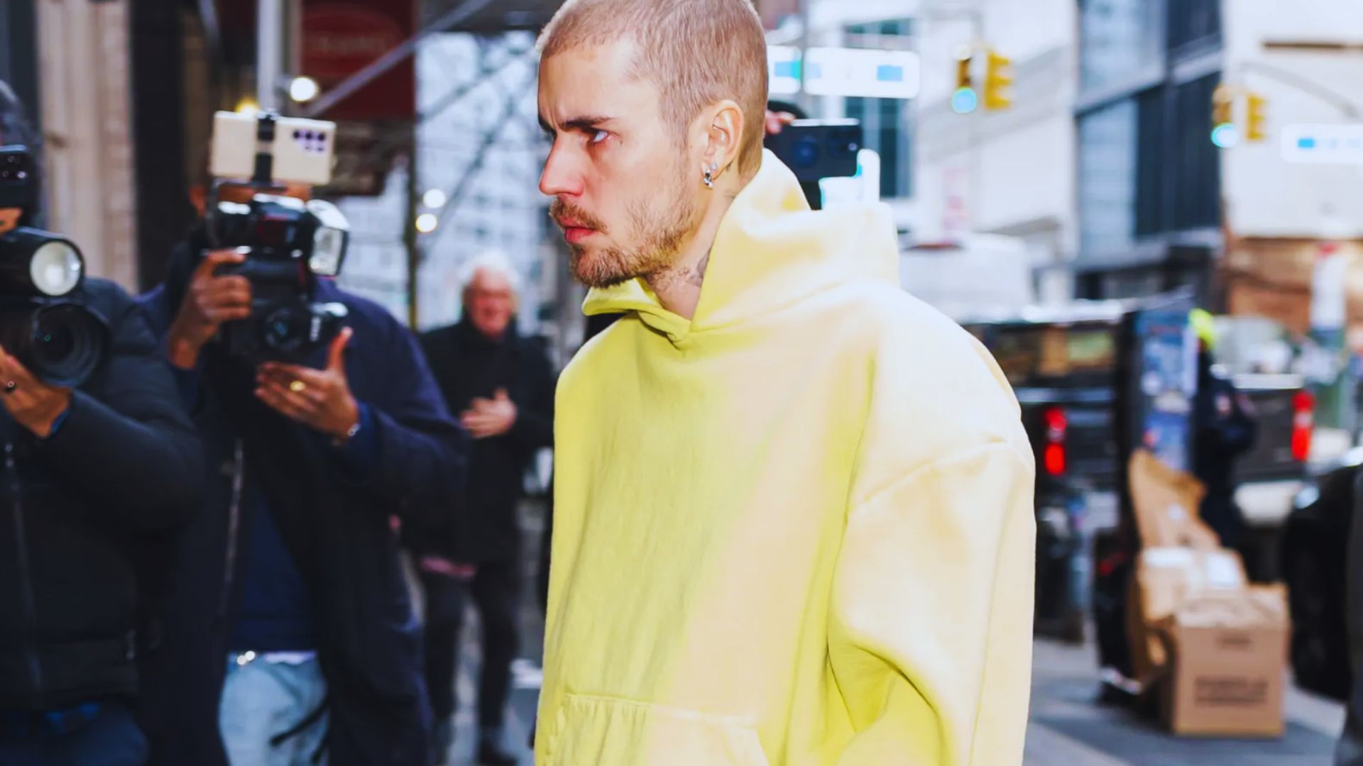 Justin Bieber models a stylish yellow hoodie, showcasing a trendy fall outfit perfect for the season.