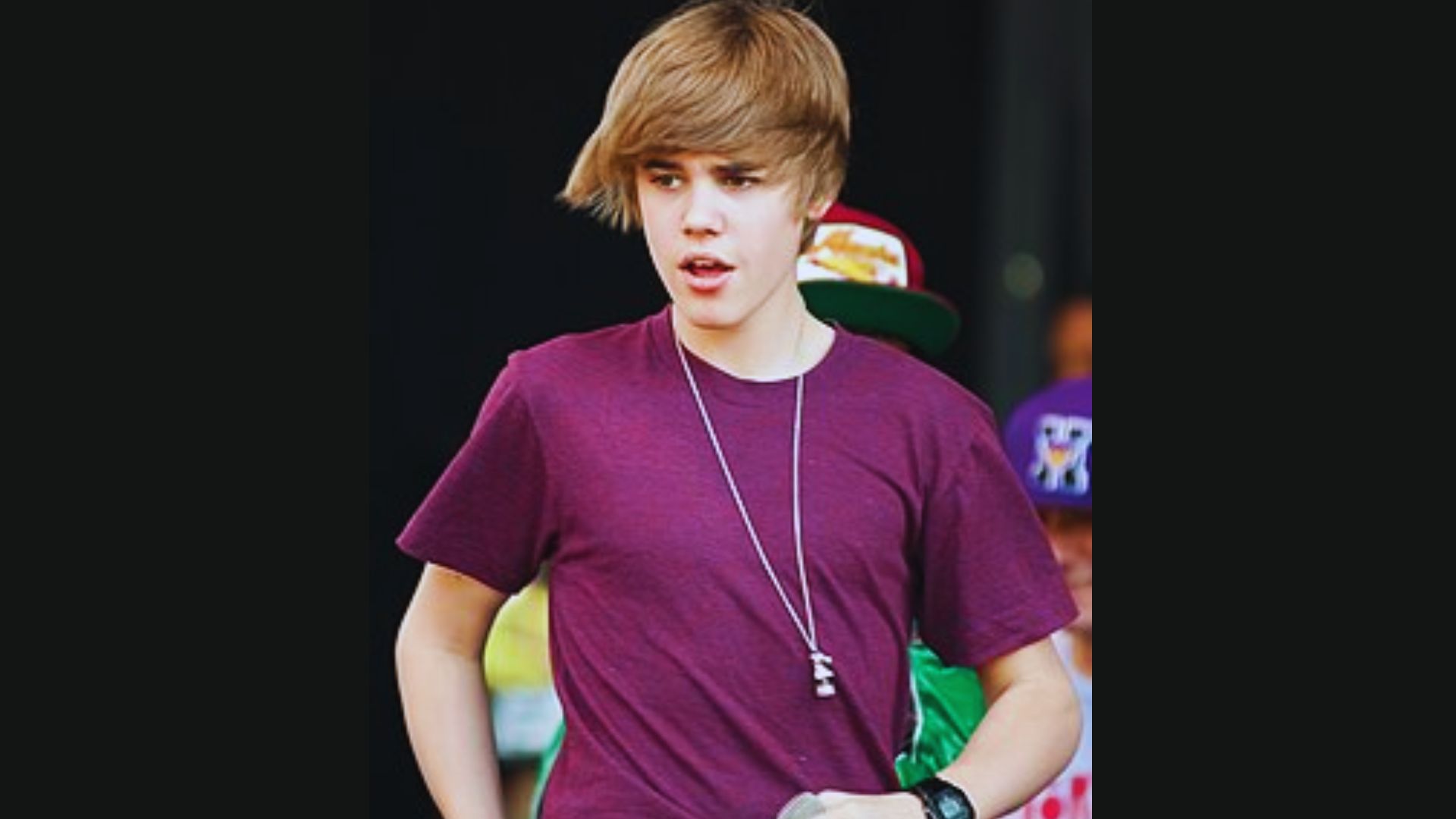 Justin Bieber performing on stage, showcasing his popularity as a renowned singer with a large audience.