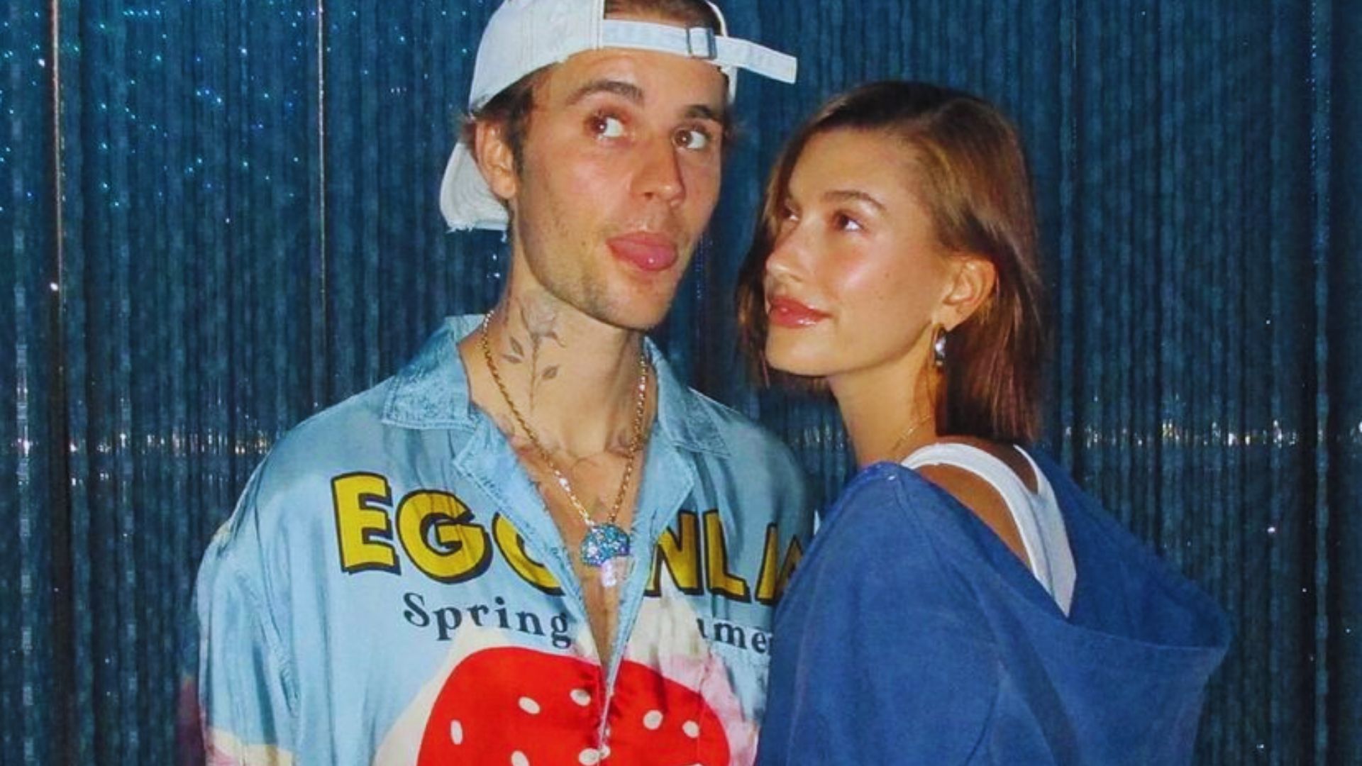A man and woman stand side by side, smiling for a picture outdoors.