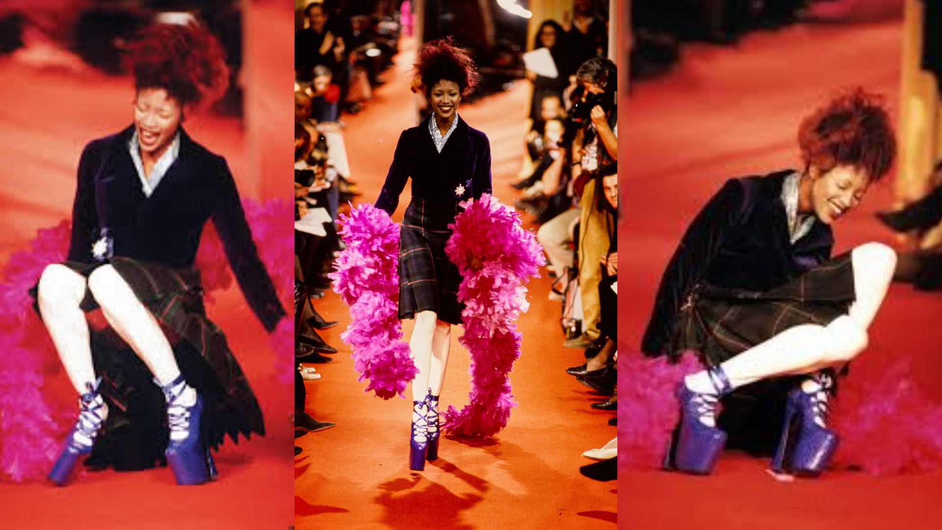 Naomi Campbell in a black dress adorned with pink feathers walks the runway and falls at a fashion show.