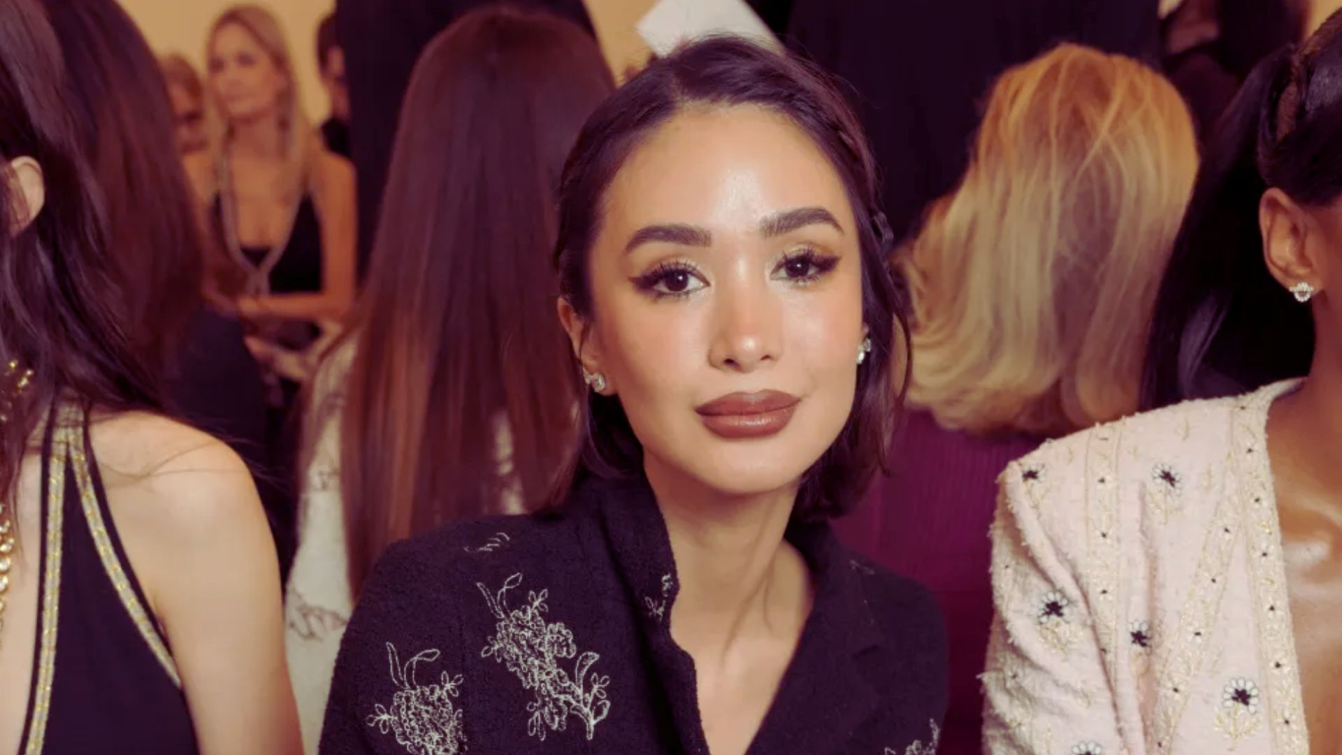 Heart Evangelista seated at a fashion show, enjoying the front-row luxury moments of the event.