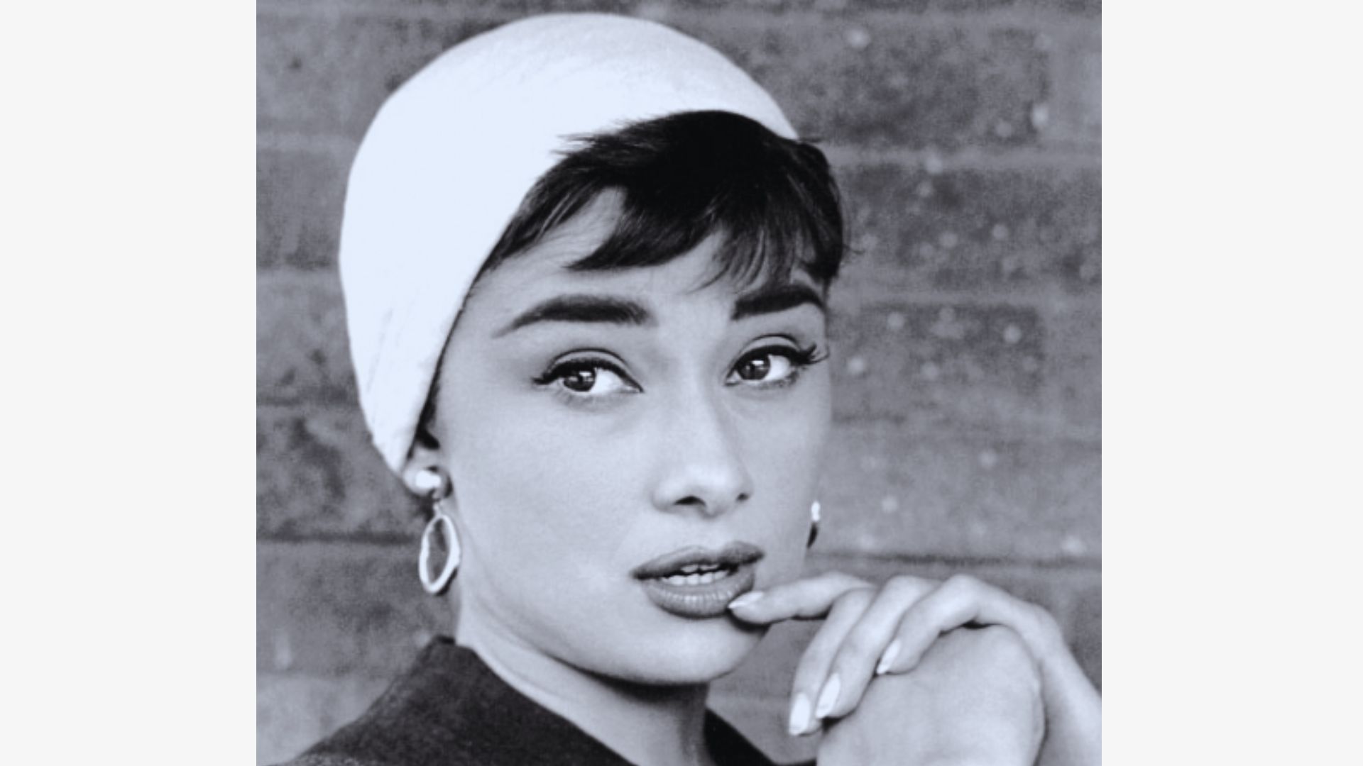 Audrey Hepburn in a classic fashion pose, featuring her iconic hairstyle and fashion.