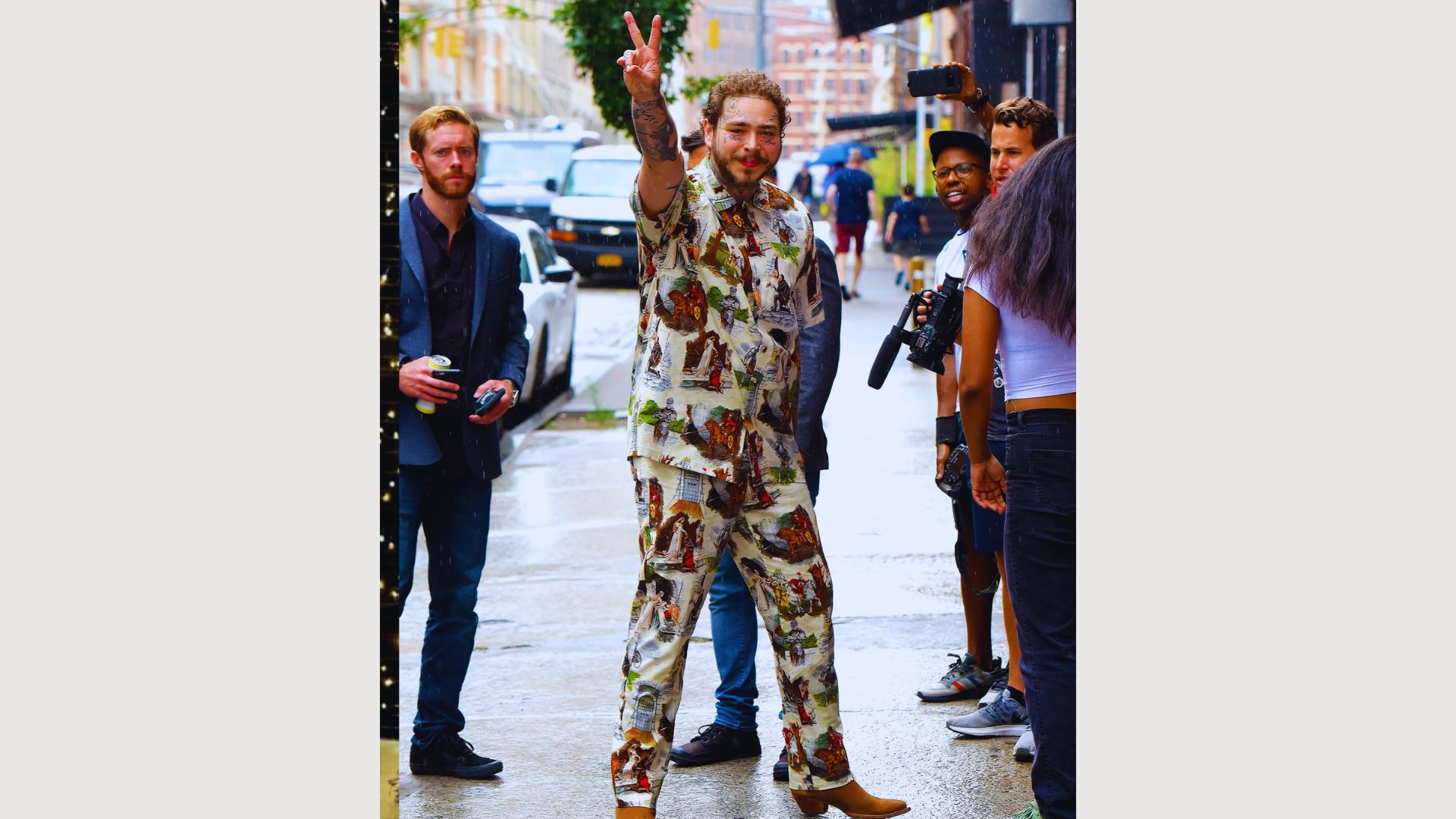 A man in a vibrant floral suit walks confidently down the street, showcasing a unique and bold fashion choice.