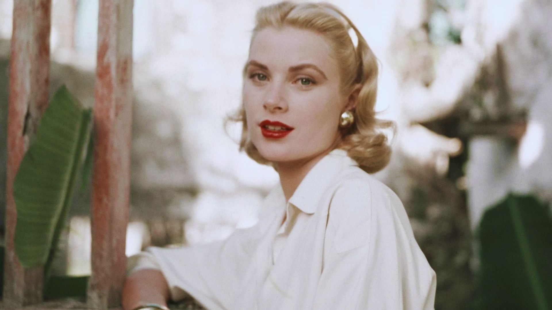 Grace Kelly captured in a serene blue light, showcasing her iconic style and graceful presence.