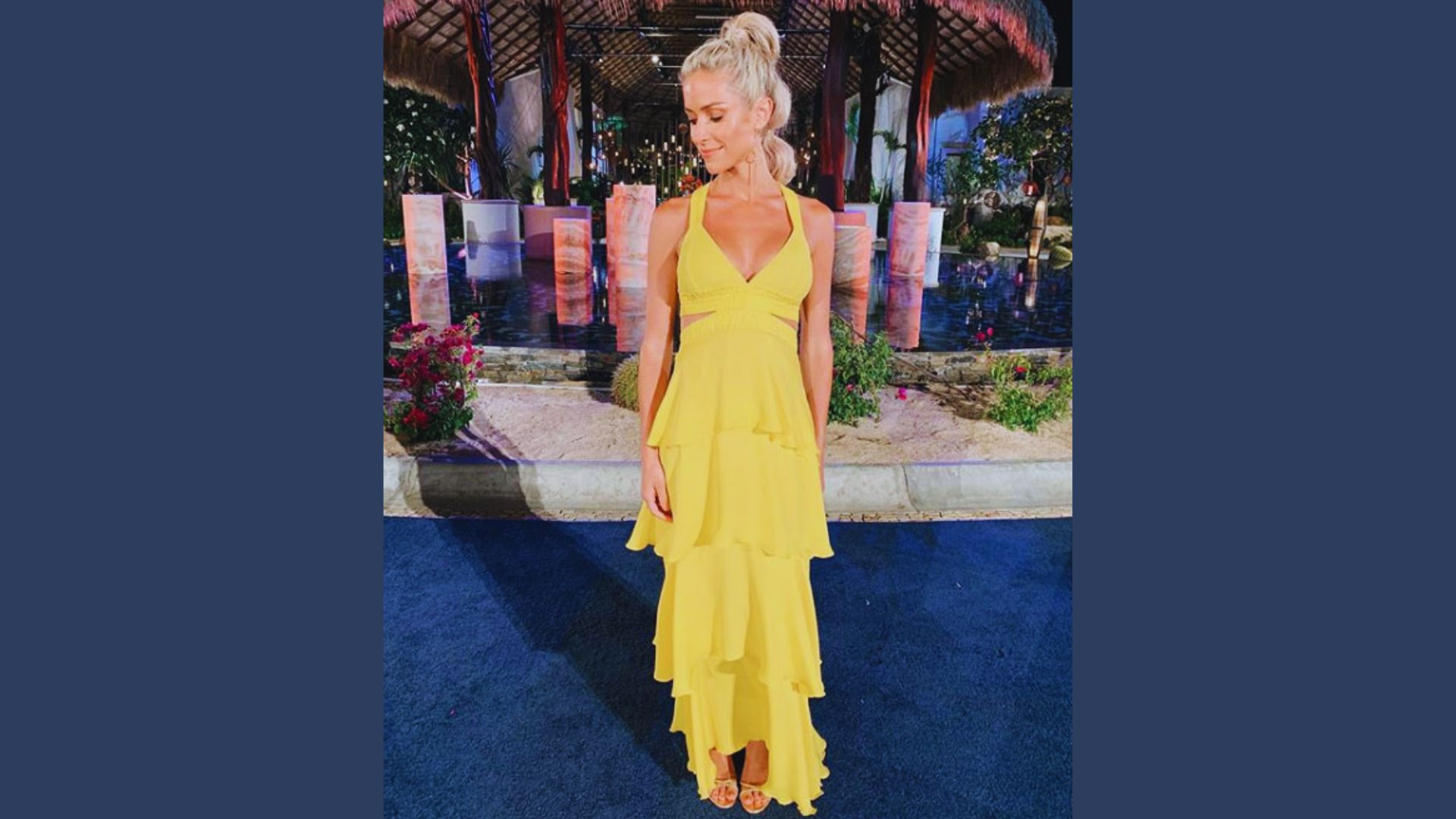 The bachelorette wearing a vibrant yellow dress, smiling and posing confidently for the camera.