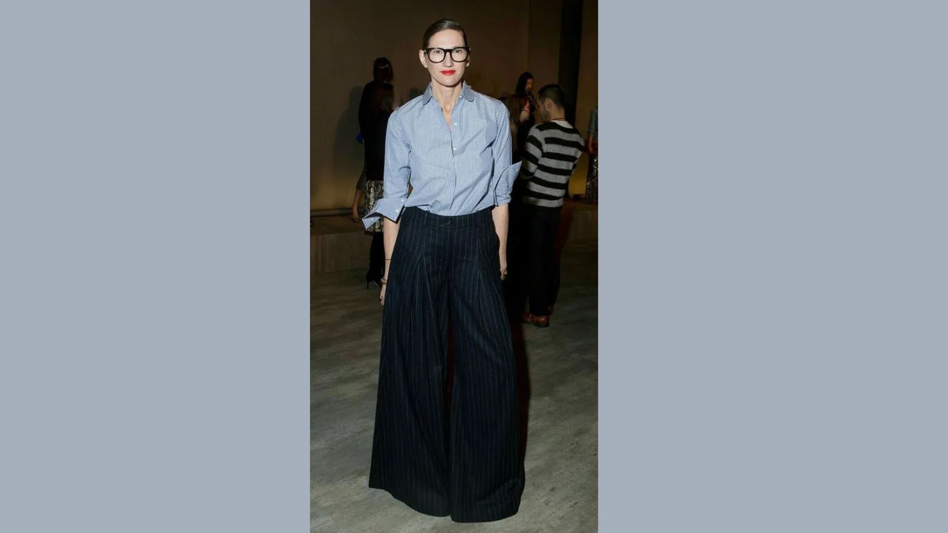 A woman in a blue shirt and black pants is depicted, representing a modern and casual style choice.