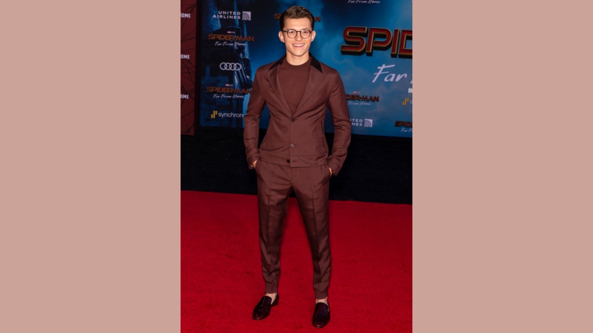 Person in a maroon suit at the Spider-Man: Far From Home premiere, showcasing a stylish monochrome look.