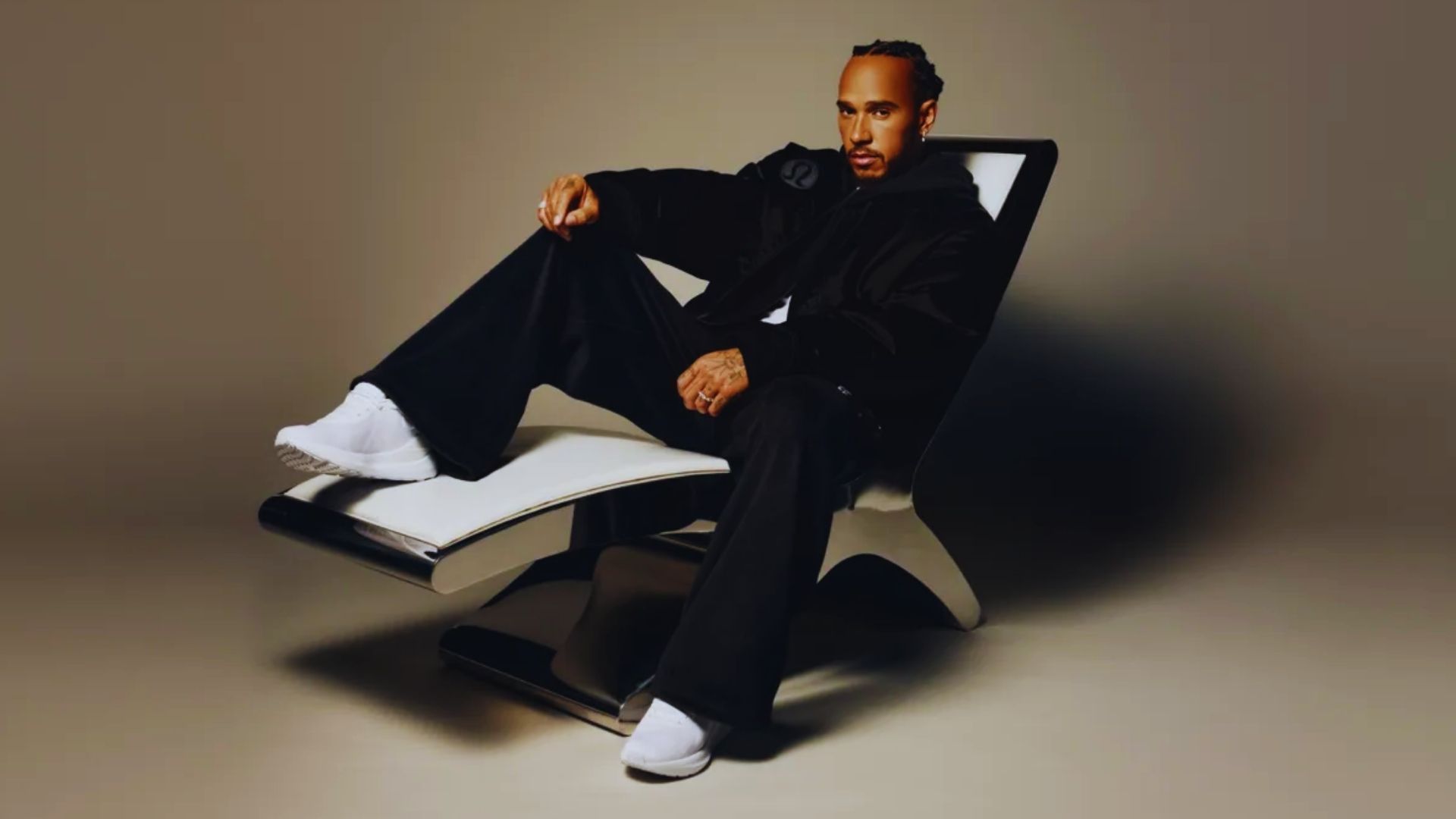 A man in a chair, feet placed firmly on the ground.
