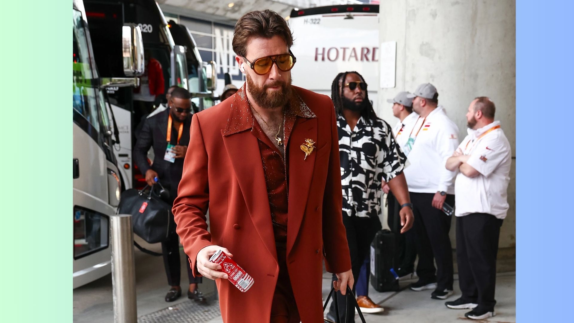 3. A man sporting a beard and sunglasses walks through a city street.