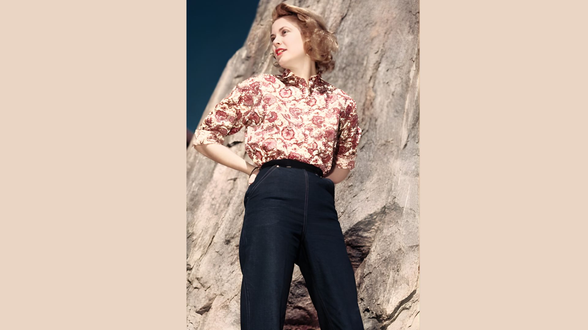 2. A woman in a floral outfit stands on a rock, showcasing her style against a natural backdrop.