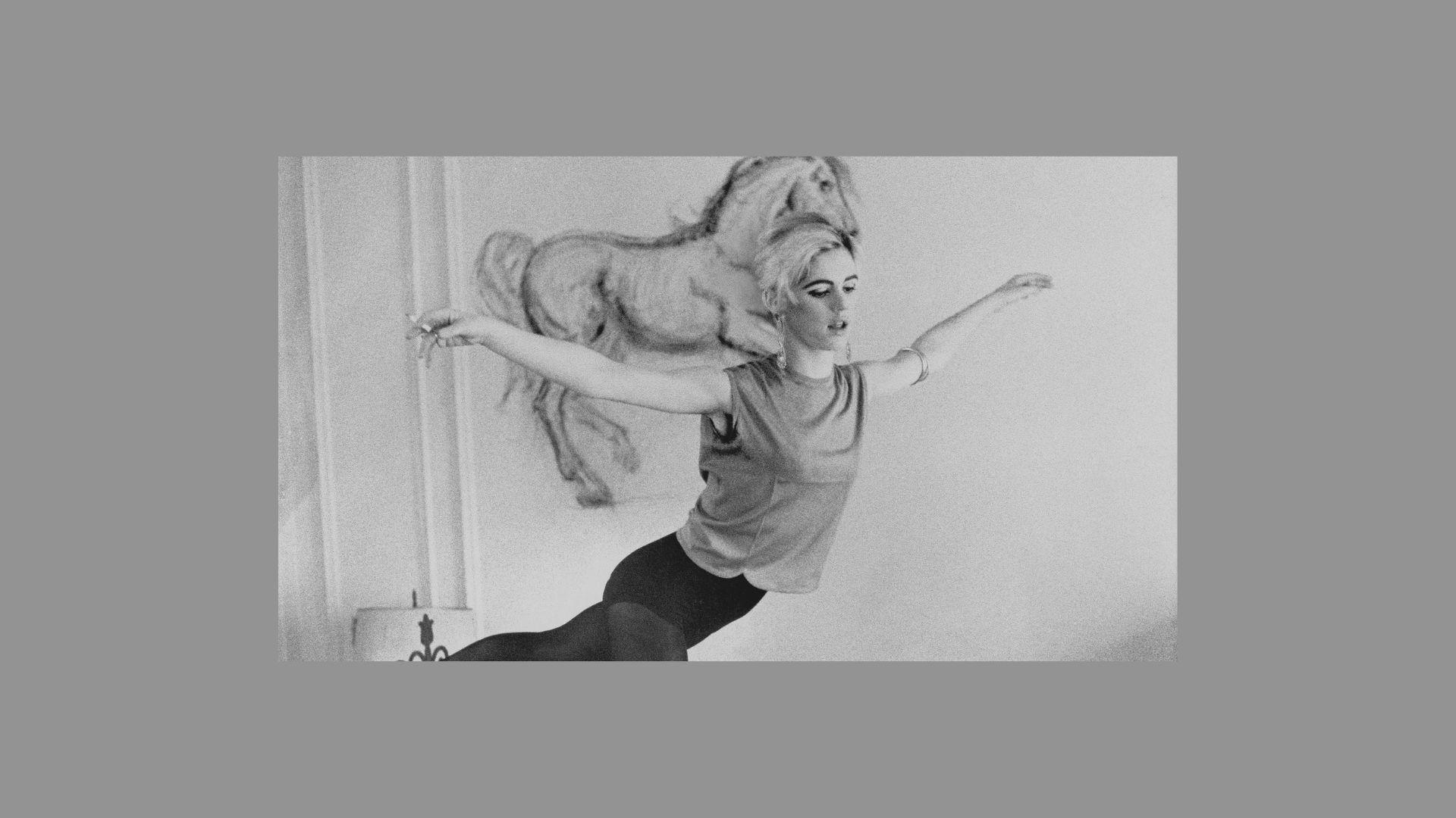 A black and white photo of a woman practicing yoga, showcasing her focus and balance in a serene pose.