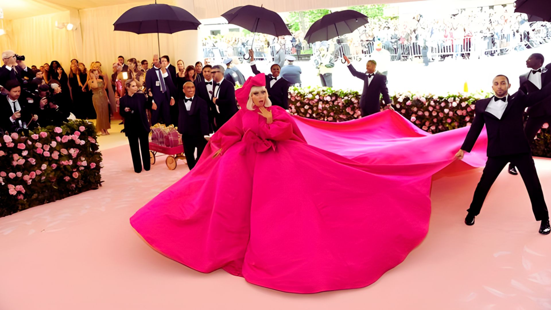 Lady Gaga at the 2019 Met Gala, wearing an extravagant, layered outfit that exemplifies maximalist fashion.