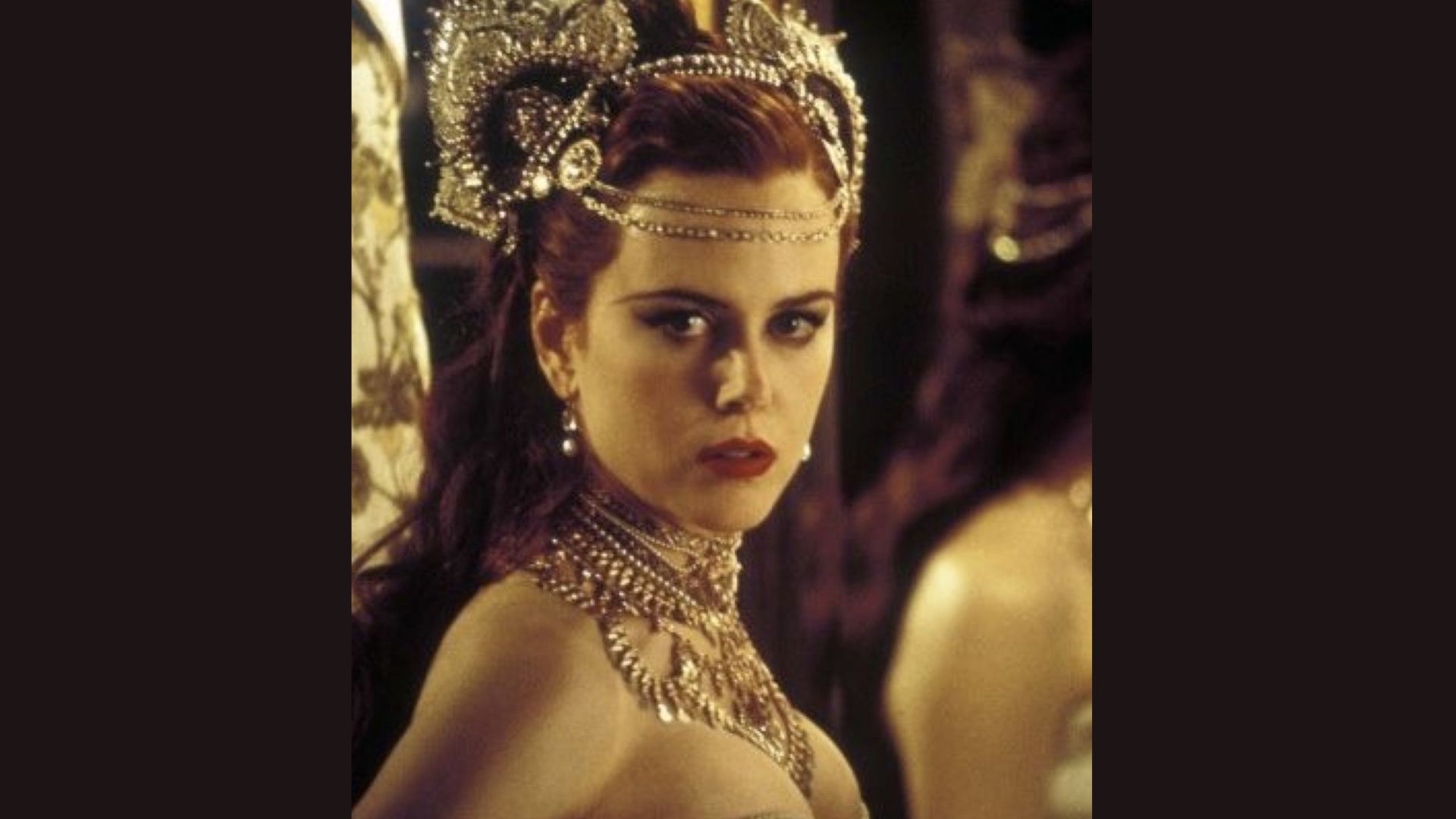 A woman with red hair adorned with an elegant headpiece, showcasing her unique style and personality.