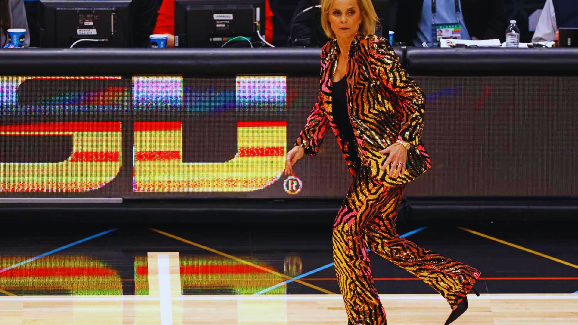 Kim Mulkey in shimmery tiger print cord set.