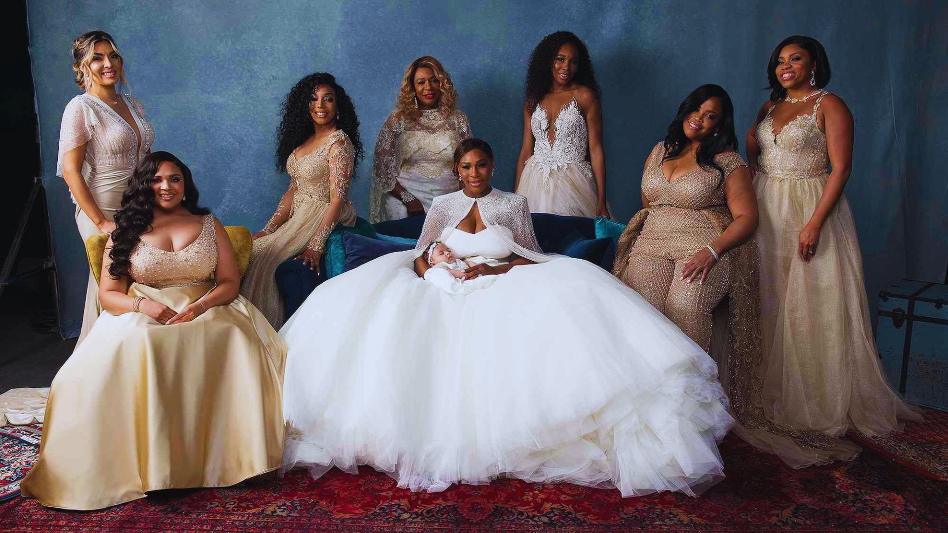 A group of bridesmaids smiling and posing together for a photo, dressed in matching dresses and holding bouquets.