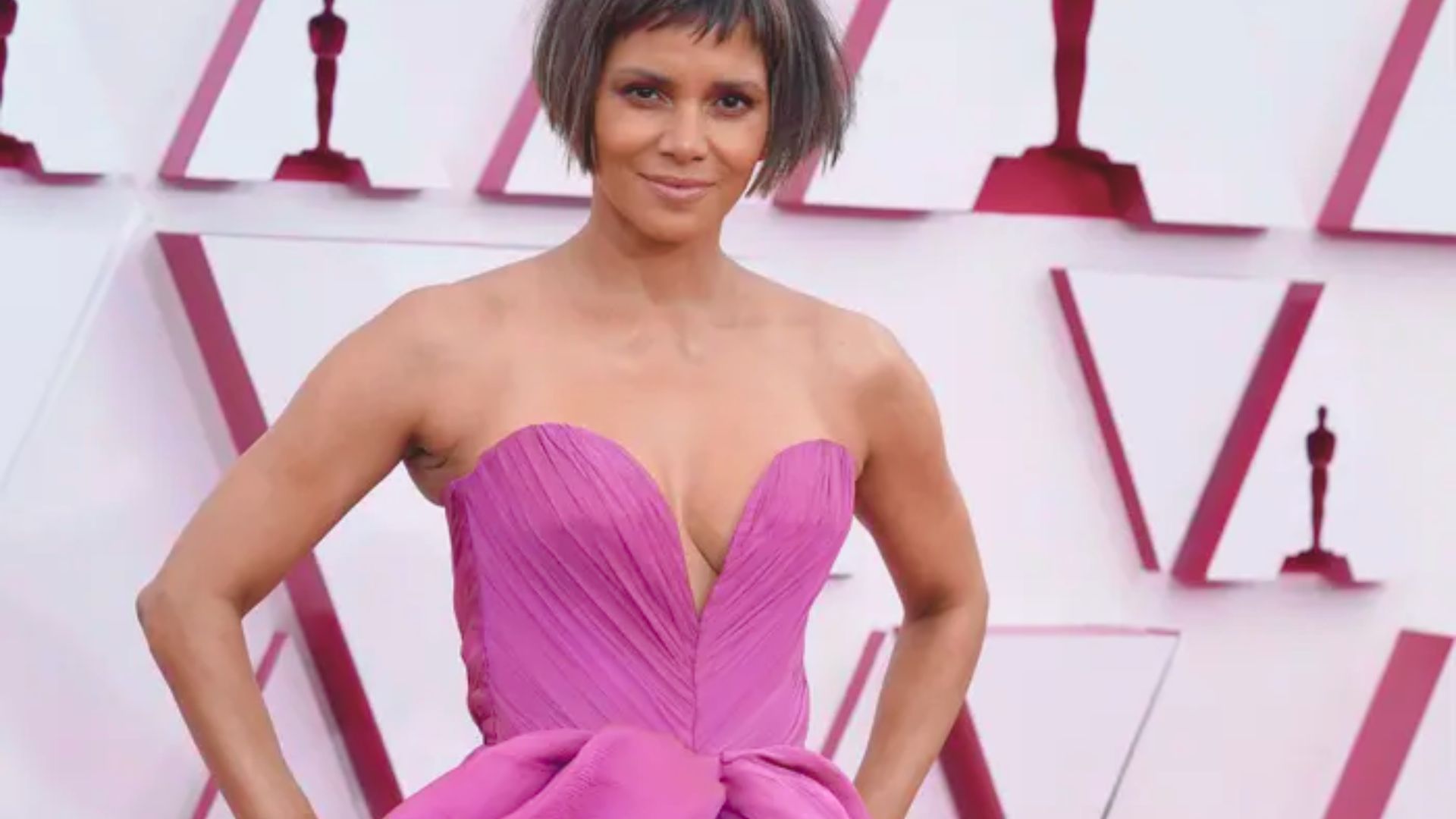 Halle Berry dazzles in a strapless, showstopping Oscars dress that highlights her elegance and style.