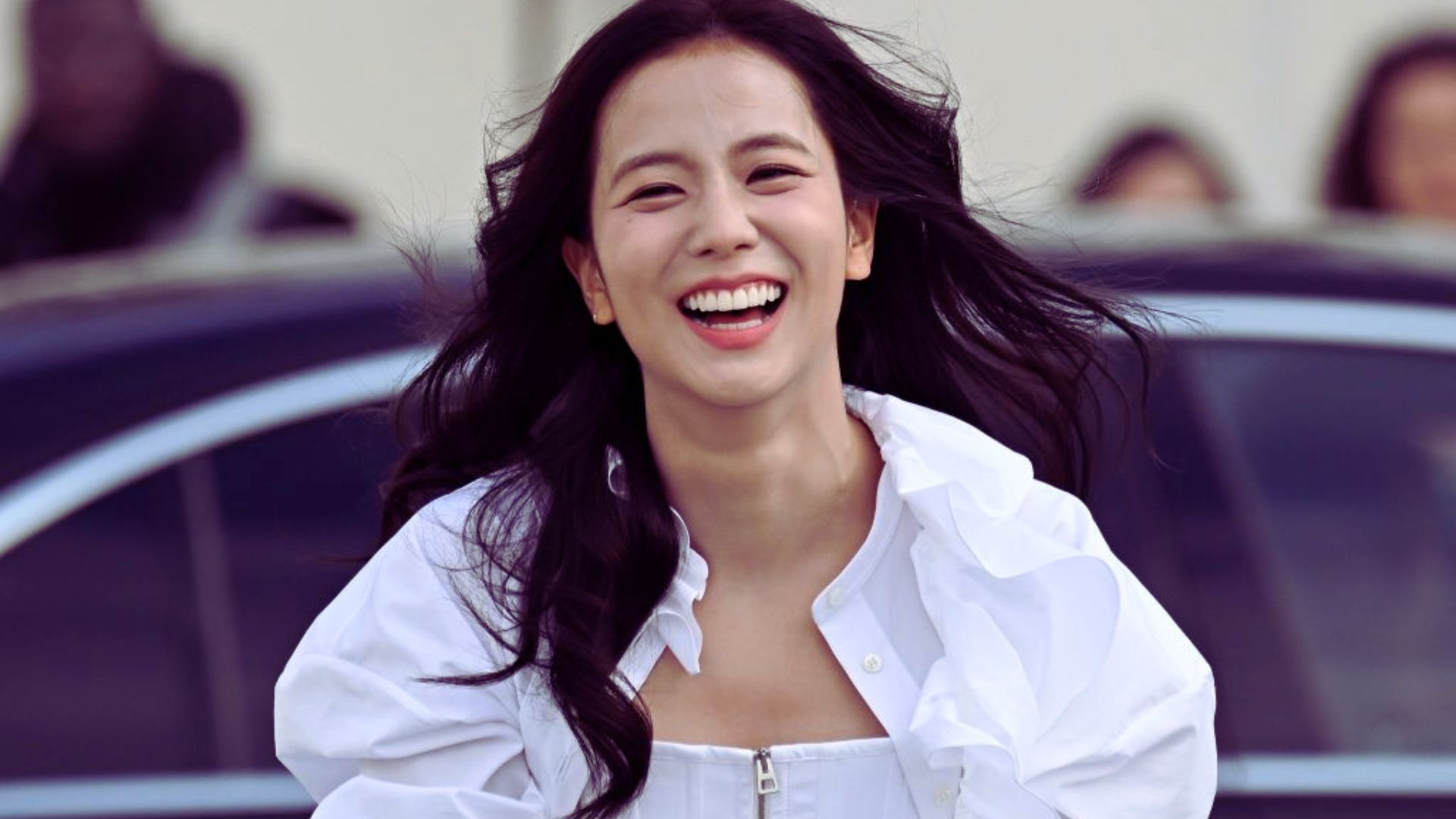 1. A smiling woman wearing a white shirt, exuding warmth and positivity.