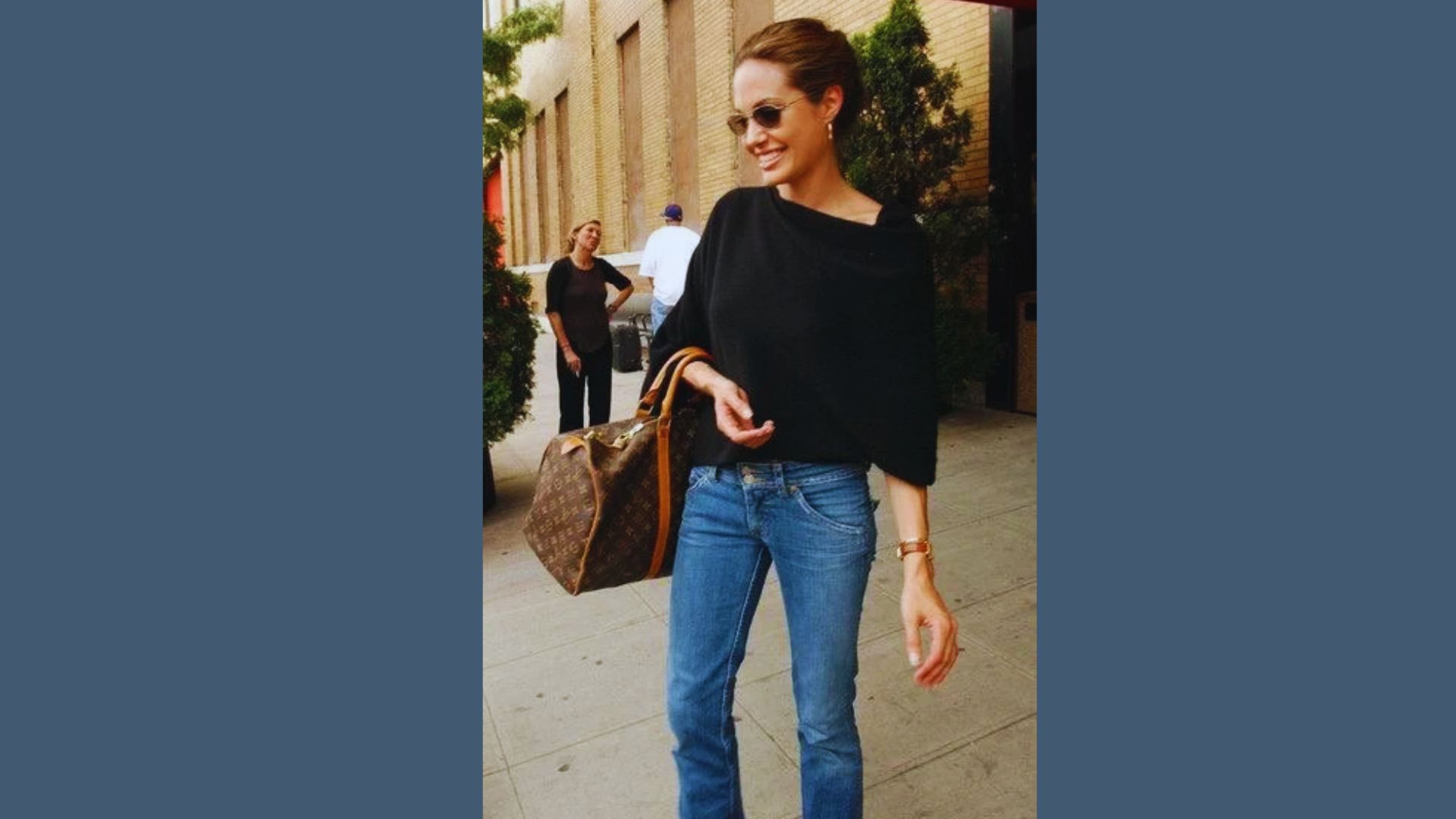 Angelina Jolie wearing a stylish black top and jeans, exemplifying an expensive-looking everyday outfit.