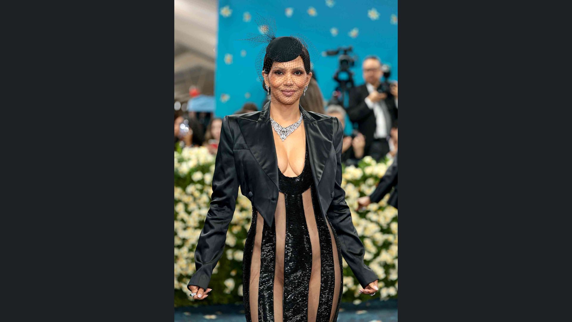 Person at the Met Gala wearing a sculpted black gown and jacket, showcasing elegant fashion and style.