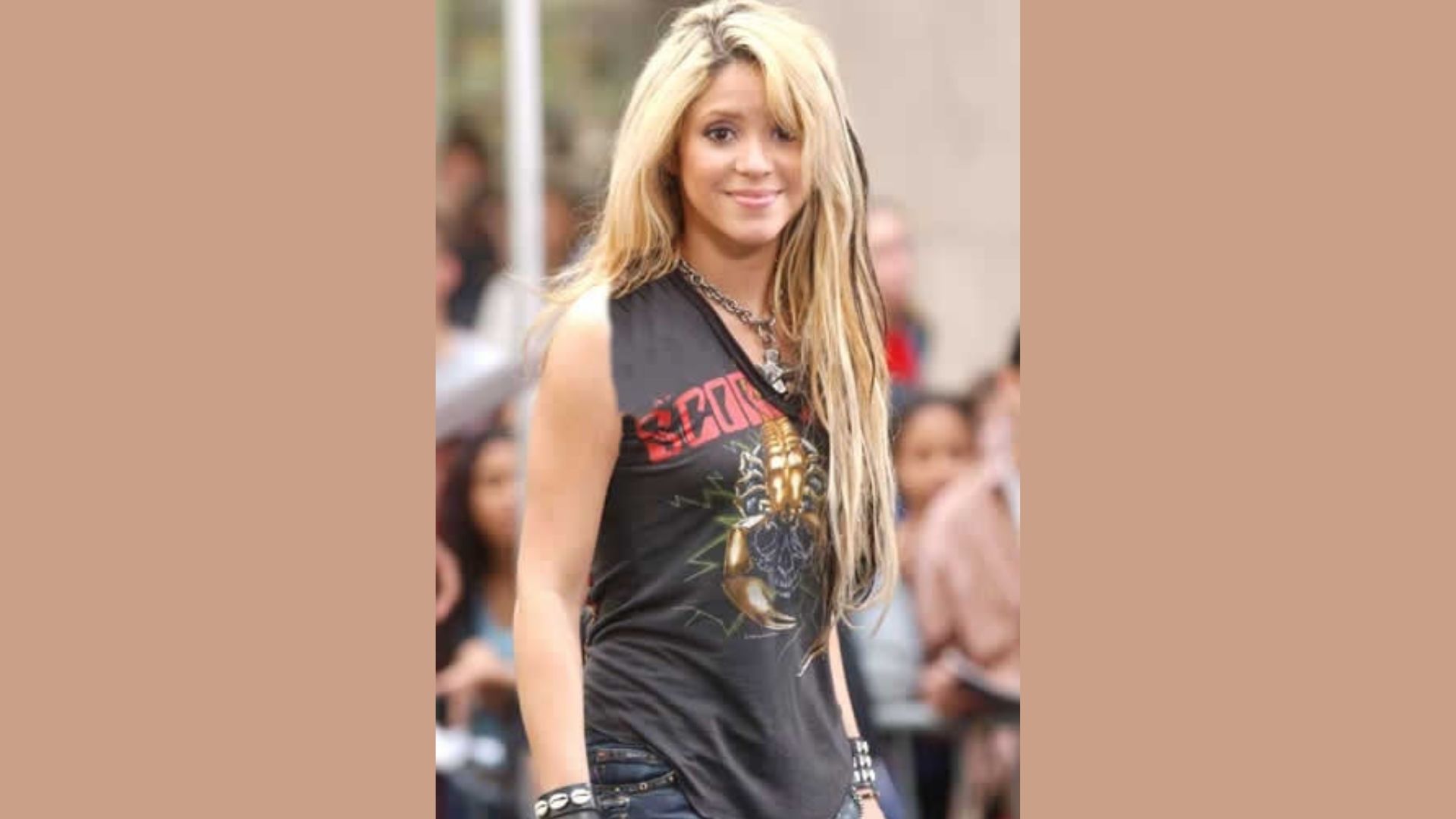 A woman with long hair wearing a black shirt, looking confidently at the camera.