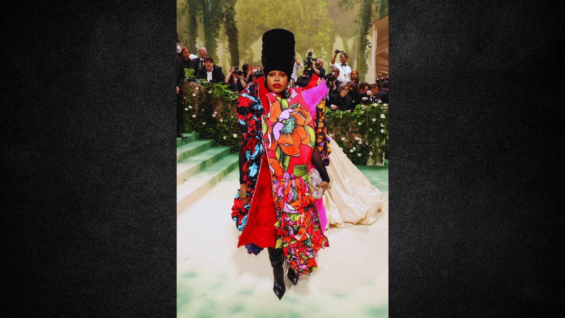 A woman in a vibrant dress confidently walks down the runway, showcasing her style and the latest fashion trends.