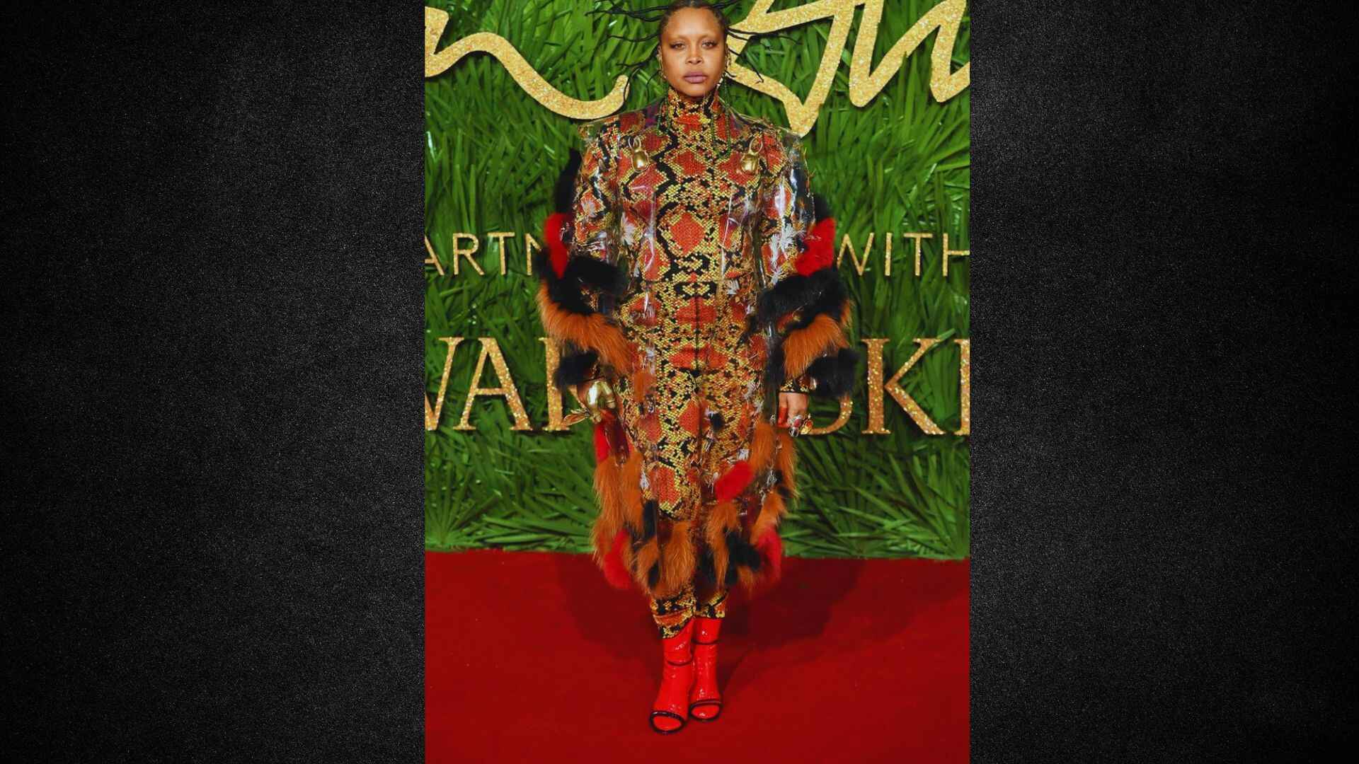 Rihanna posing elegantly at the British Fashion Awards, showcasing her stylish outfit and confident demeanor.