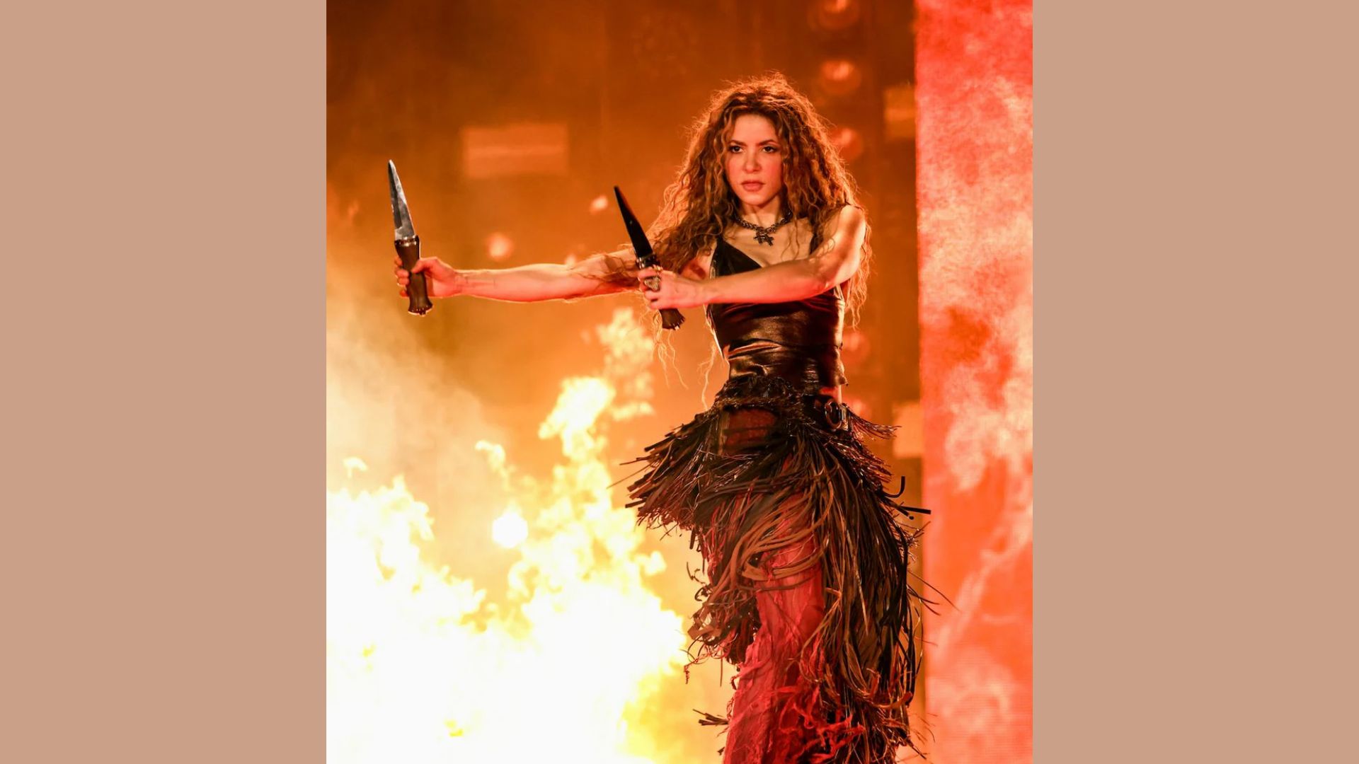 A woman in a black dress holds two knives, poised and ready, with a serious expression on her face.