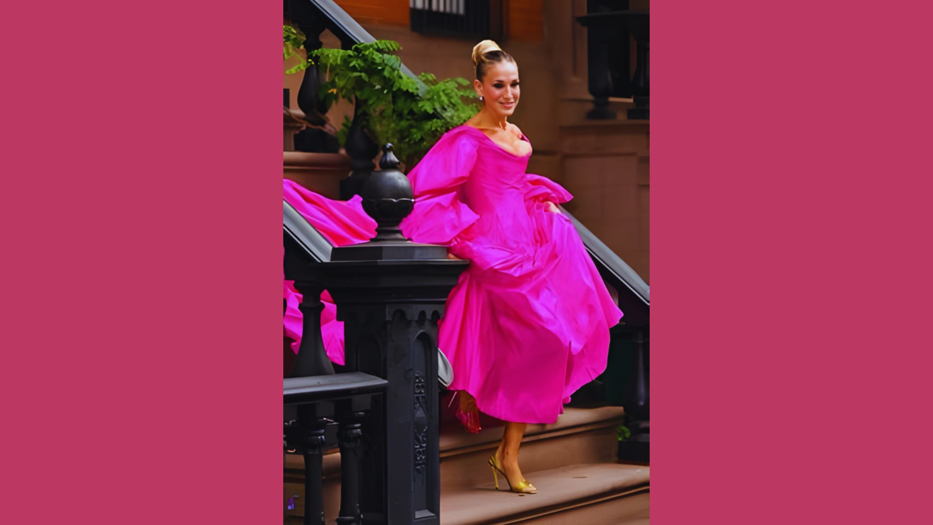 A woman in a pink dress stands gracefully on a staircase, showcasing her elegant pose and the surrounding architecture.