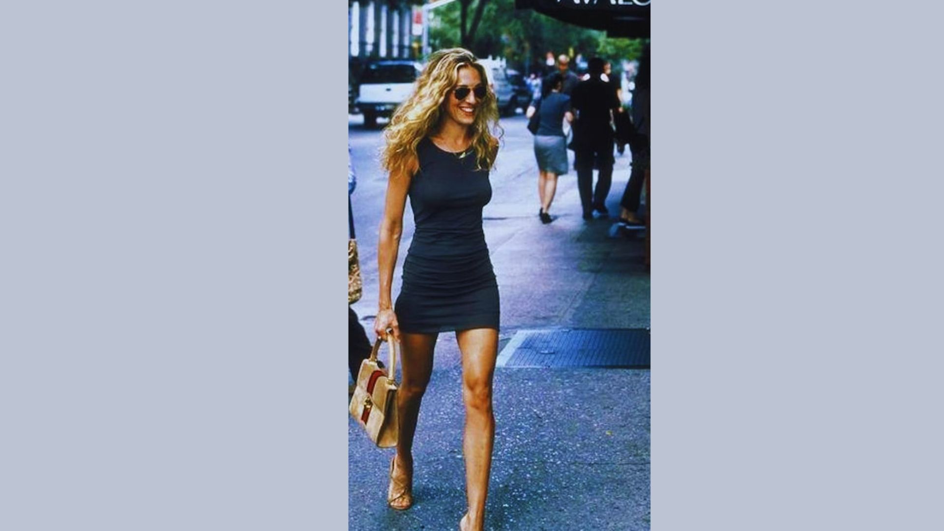 A woman in a short dress walks confidently down a city street, surrounded by urban scenery.