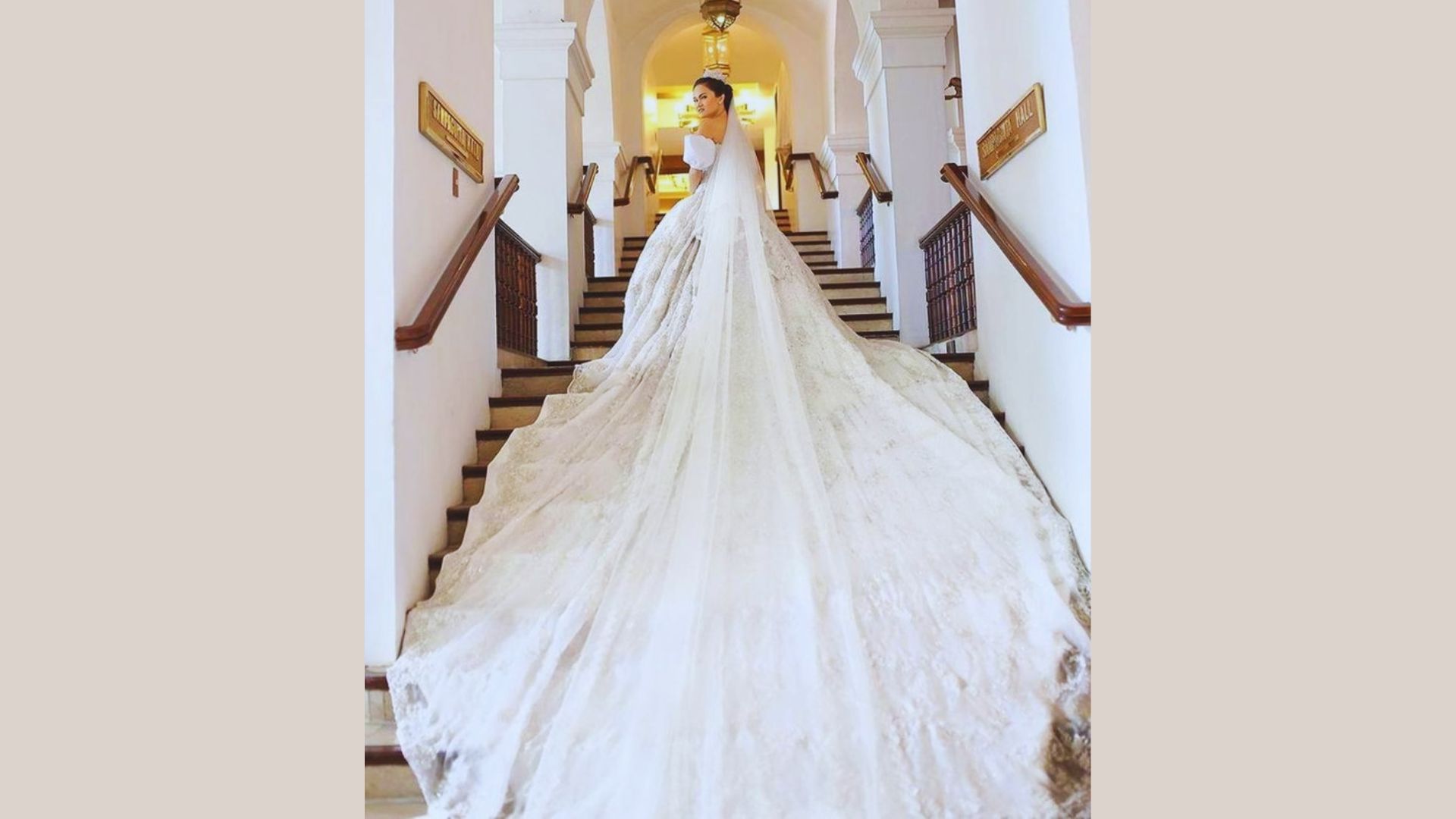A bride gracefully descends the stairs in a flowing, elegant wedding dress, radiating joy on her special day.