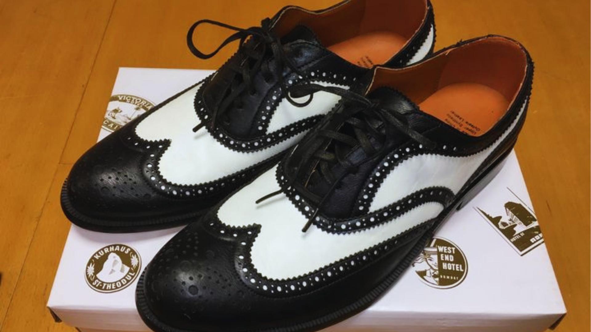 Close-up of black and white wingtip spectator brogue dress shoes from La La Land on shoe box