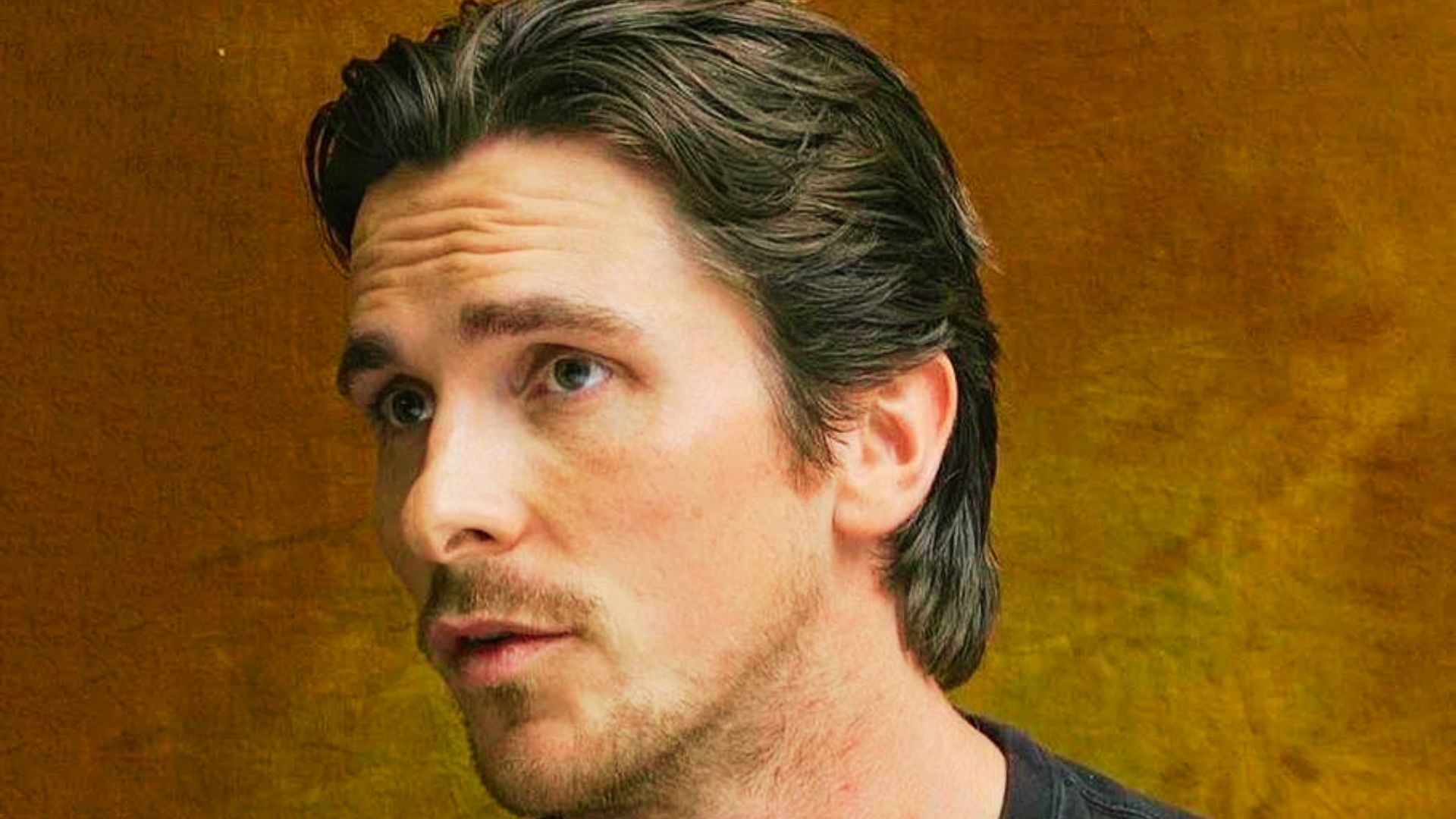 Christian Bale as Batman in The Batman Begins, showcasing his iconic hairstyle from the film.