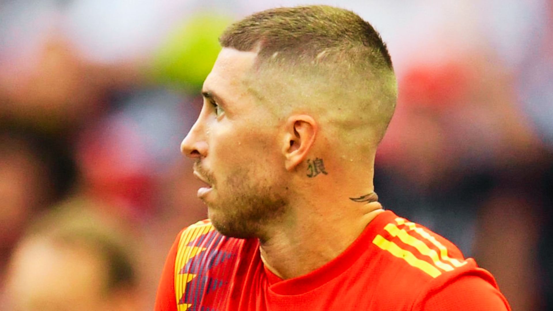 Sergio Ramos with a buzz cut and a tattoo on his arm, showcasing his World Cup 2018 look.
