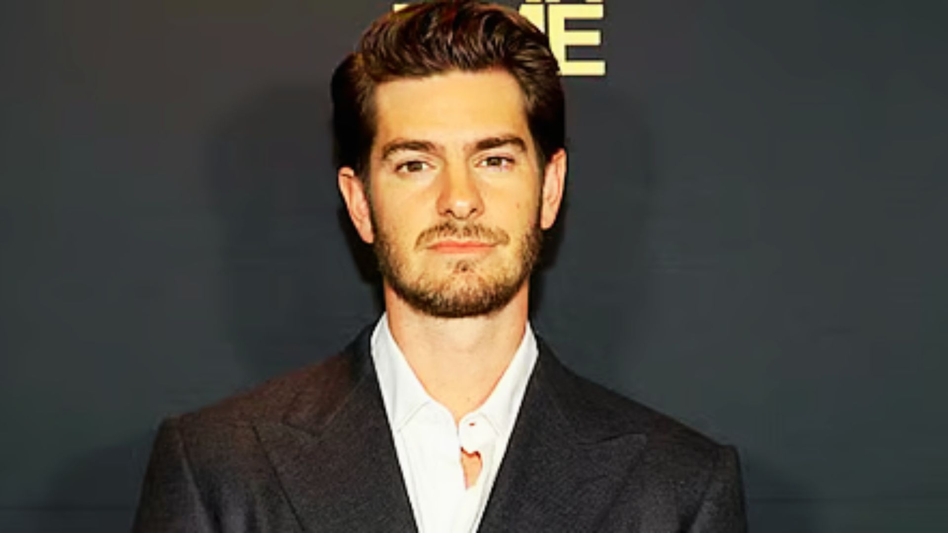 Andrew Garfield in a suit and white shirt, demonstrating a stylish look.