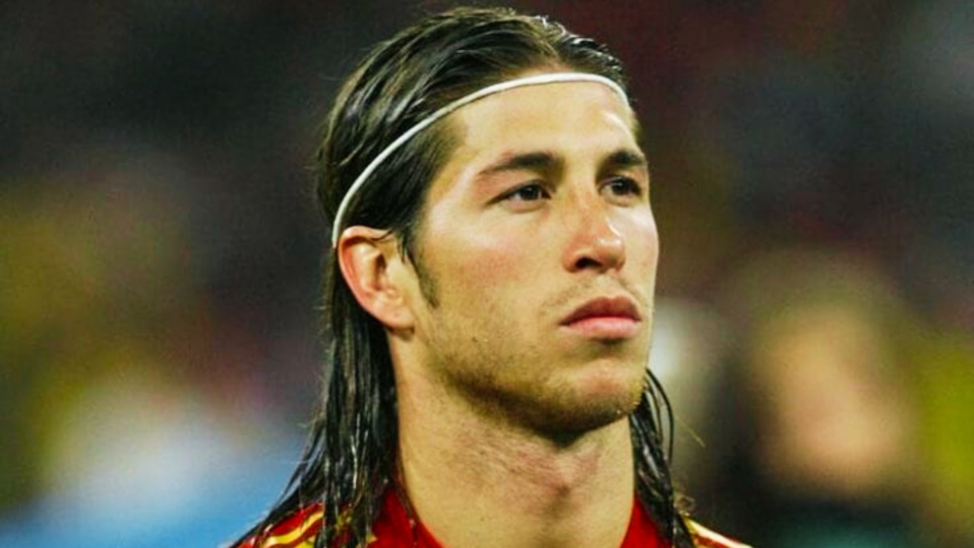 Sergio Ramos with long hair wearing a red shirt, showcasing early career hairstyle.