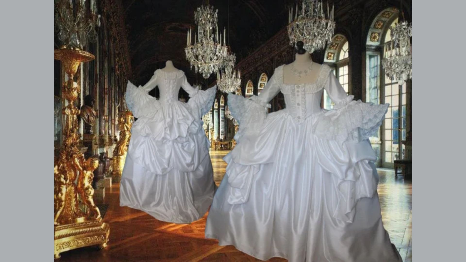 "Two elegant white wedding gowns displayed in a room adorned with sparkling chandeliers."