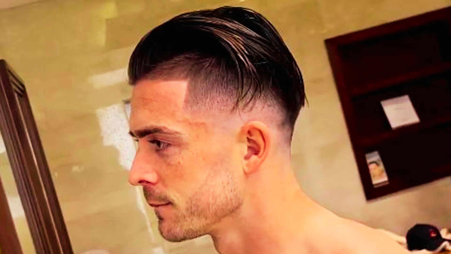 Jack Grealish with a shaved head, demonstrating haircut style for barbers.