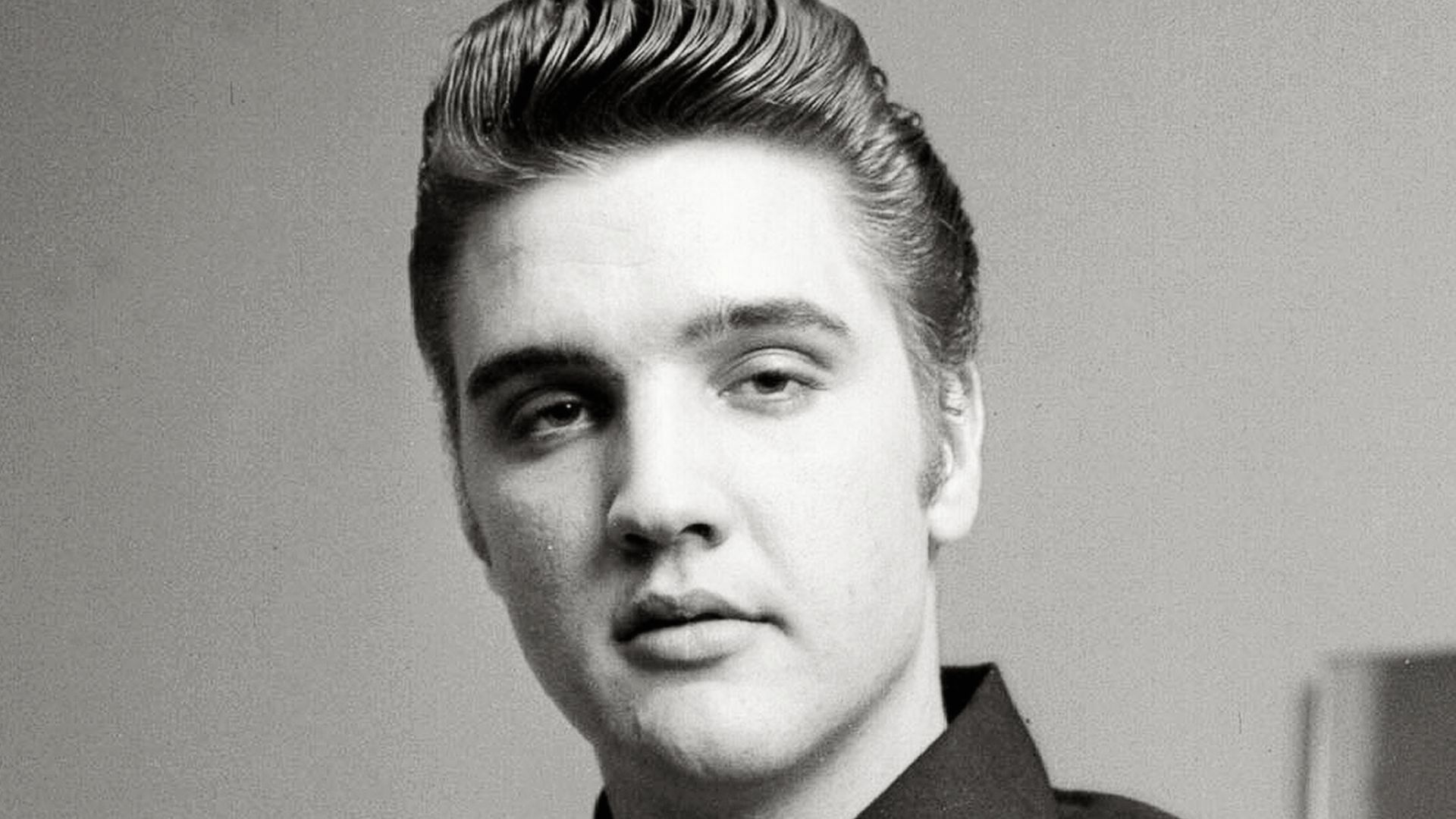 Elvis Presley Jr. with a modern haircut with fade.