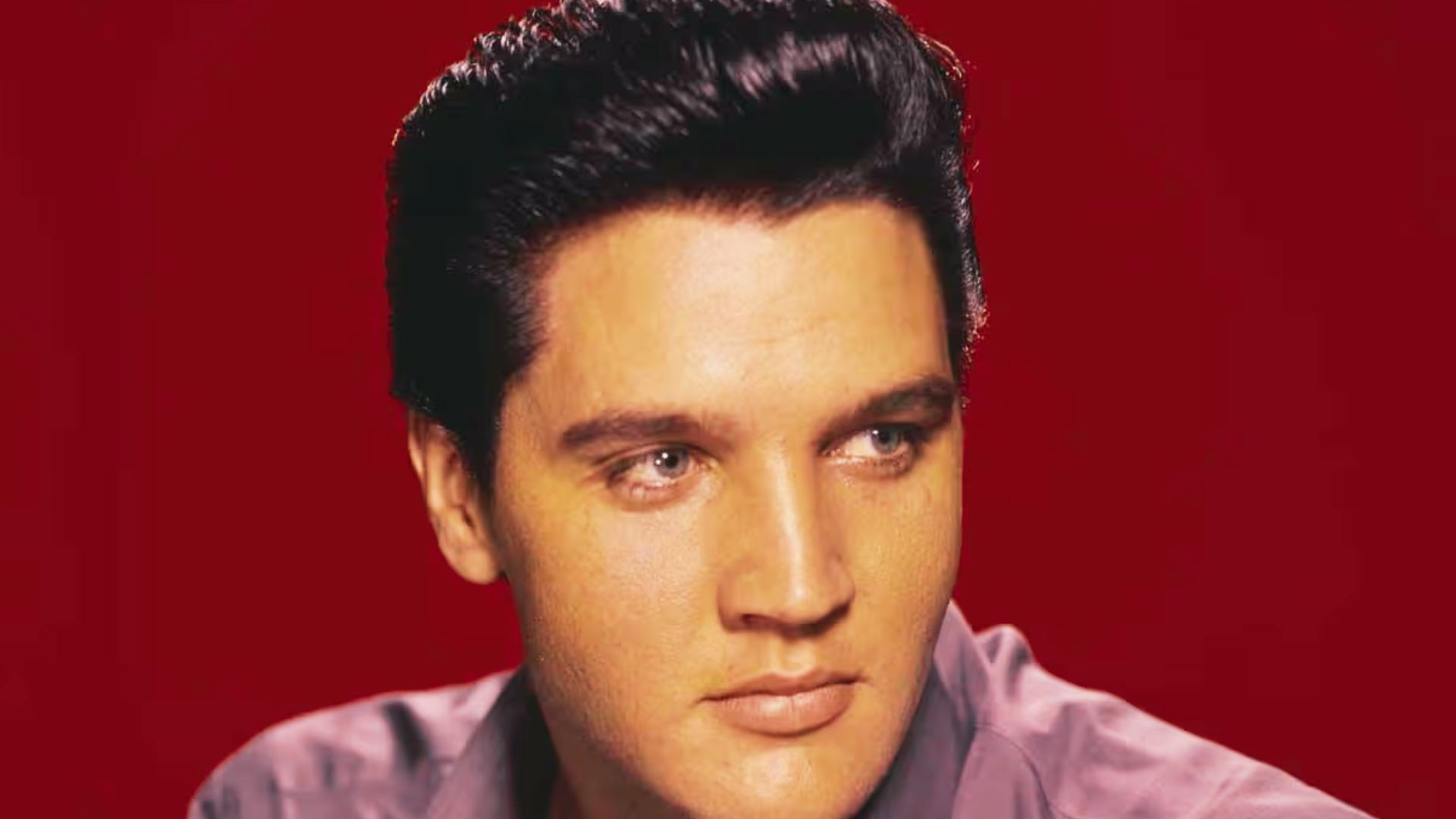 Elvis Presley, the King of Rock and Roll, showcasing his iconic hairstyle and fashion style tips for fans.