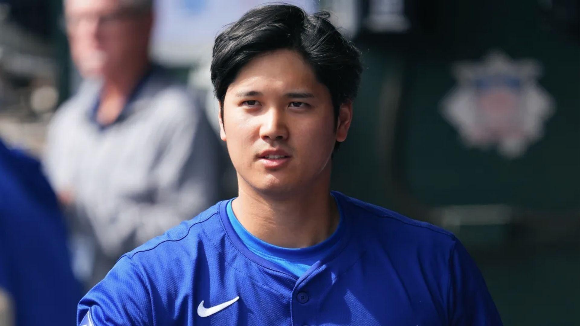 Shohei Ohtani in blue jersey sporting tousled medium-length haircut on field