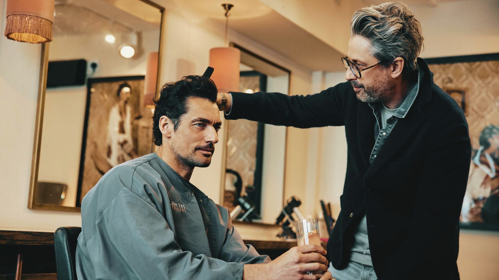 Gandy is getting his hair styled by a barber, showcasing a professional haircutting process.