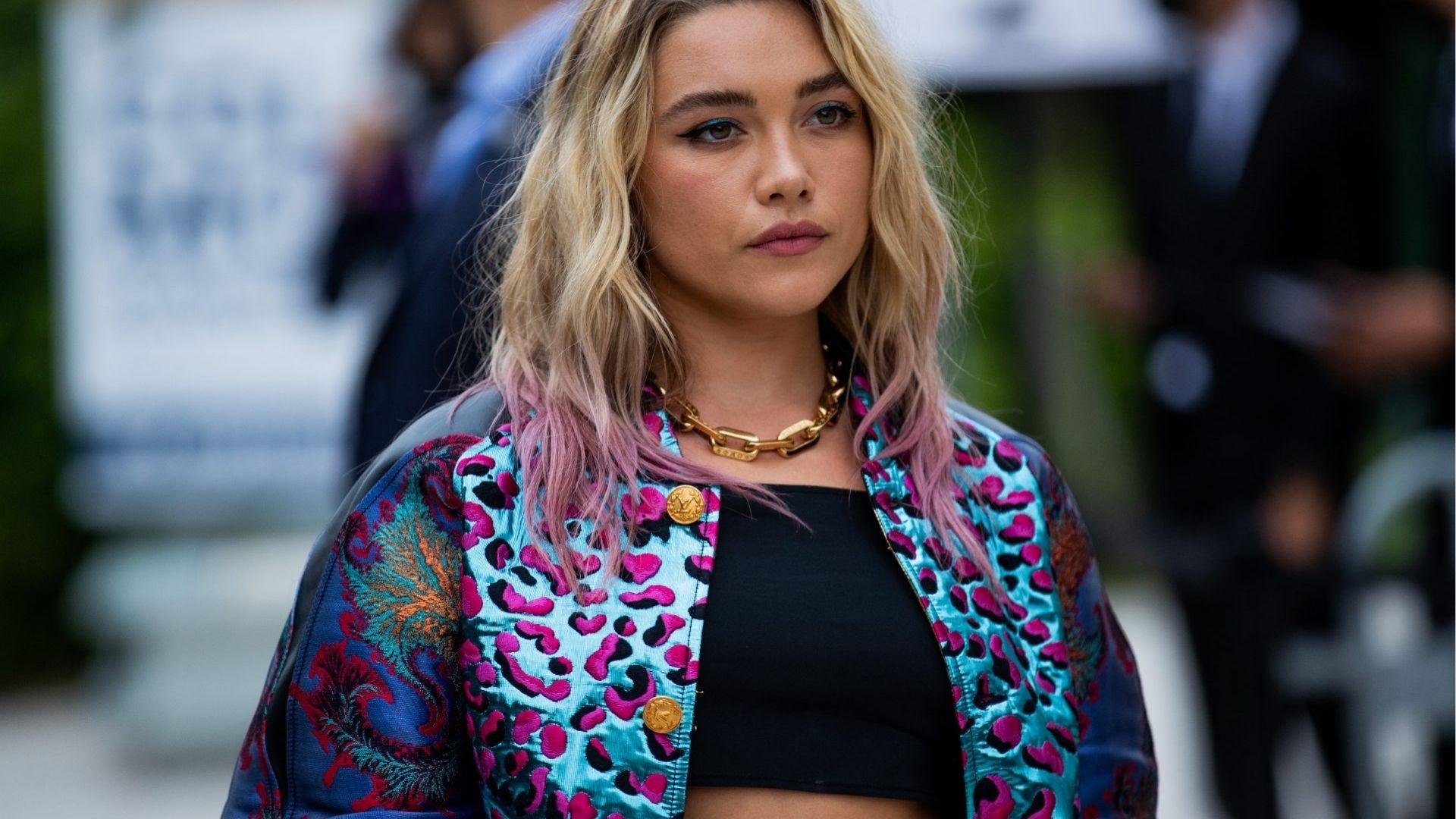 Florence Pugh mixes punk glam in a leopard print jacket with pink tips and gold chain.
