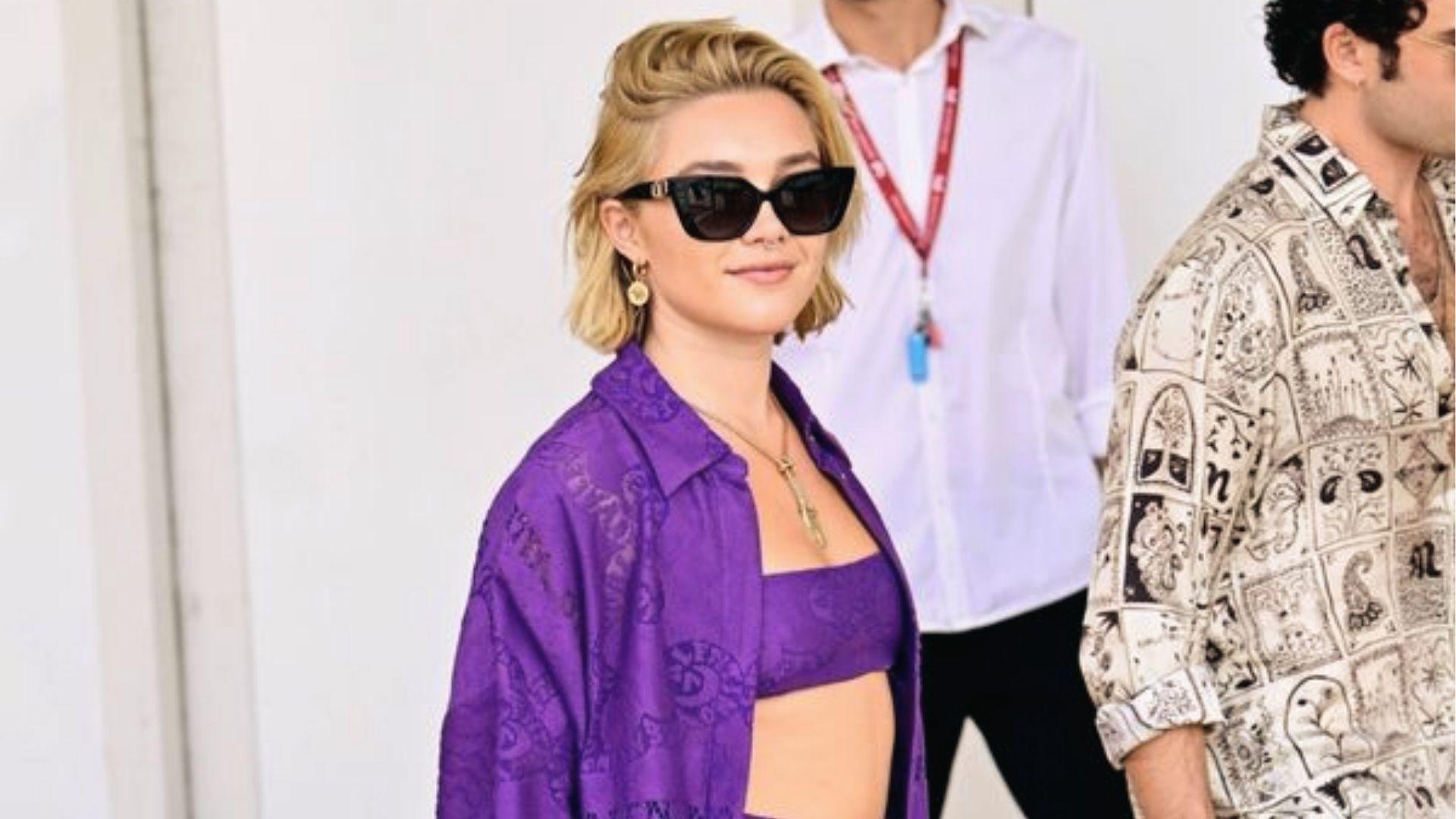 Florence Pugh rocks a bold purple co-ord set with cat-eye shades for effortless cool.