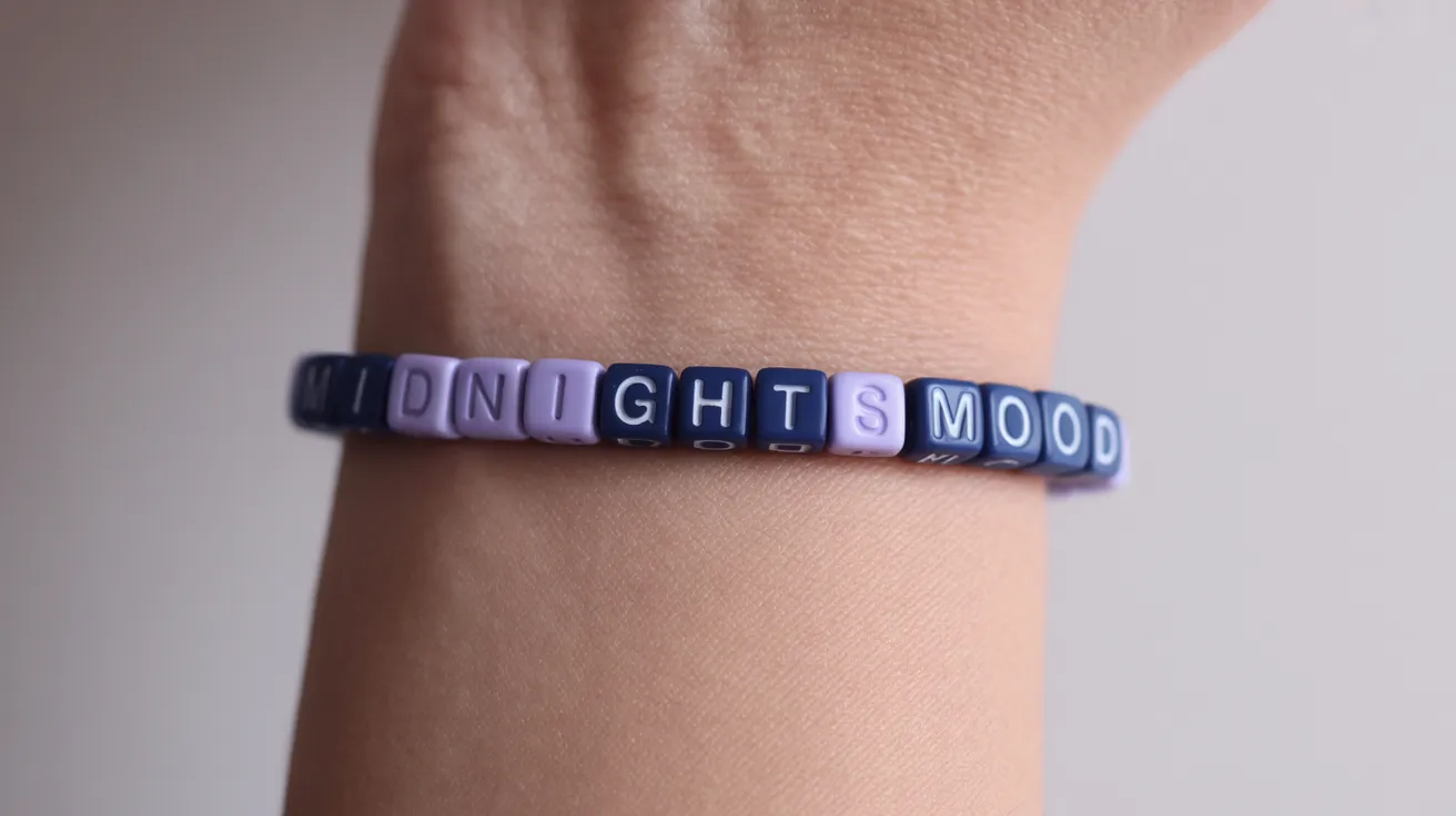 wrist wearing a navy and lavender bracelet with cube beads spelling MIDNIGHTS MOOD in bold uppercase.