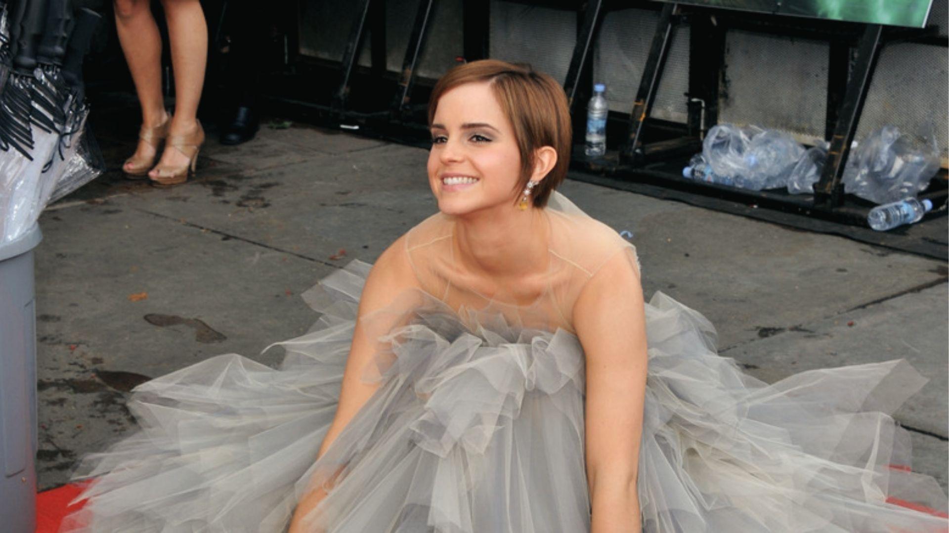 Emma Watson sits in a tulle gown showcasing layered pixie cut with side parts.