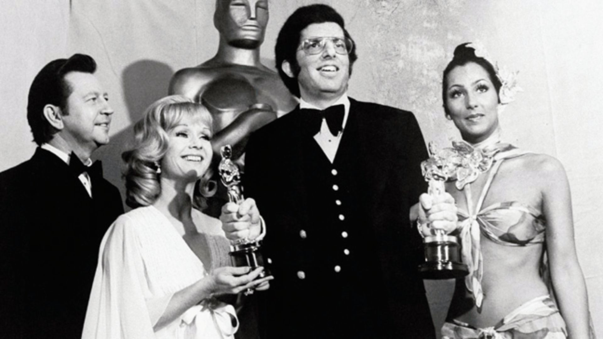 Cher at the 1973 Oscars in a controversial Bob Mackie tie-front bikini top and matching skirt.