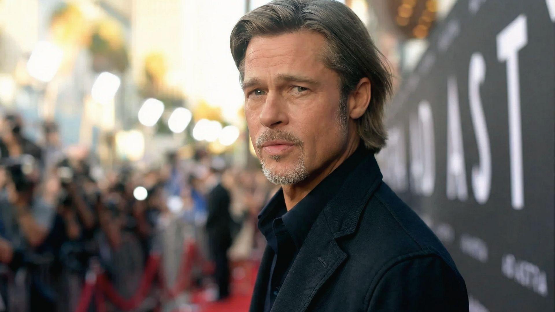 Brad Pitt with medium length hair, warm lighting at formal event.