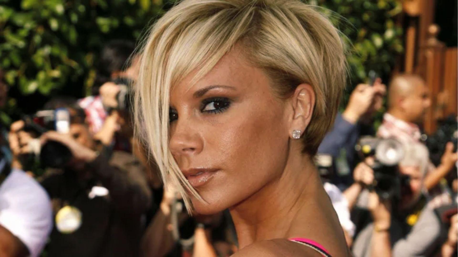 Victoria Beckham rocks iconic asymmetrical blonde Pob bob haircut with smoky eye glam.
