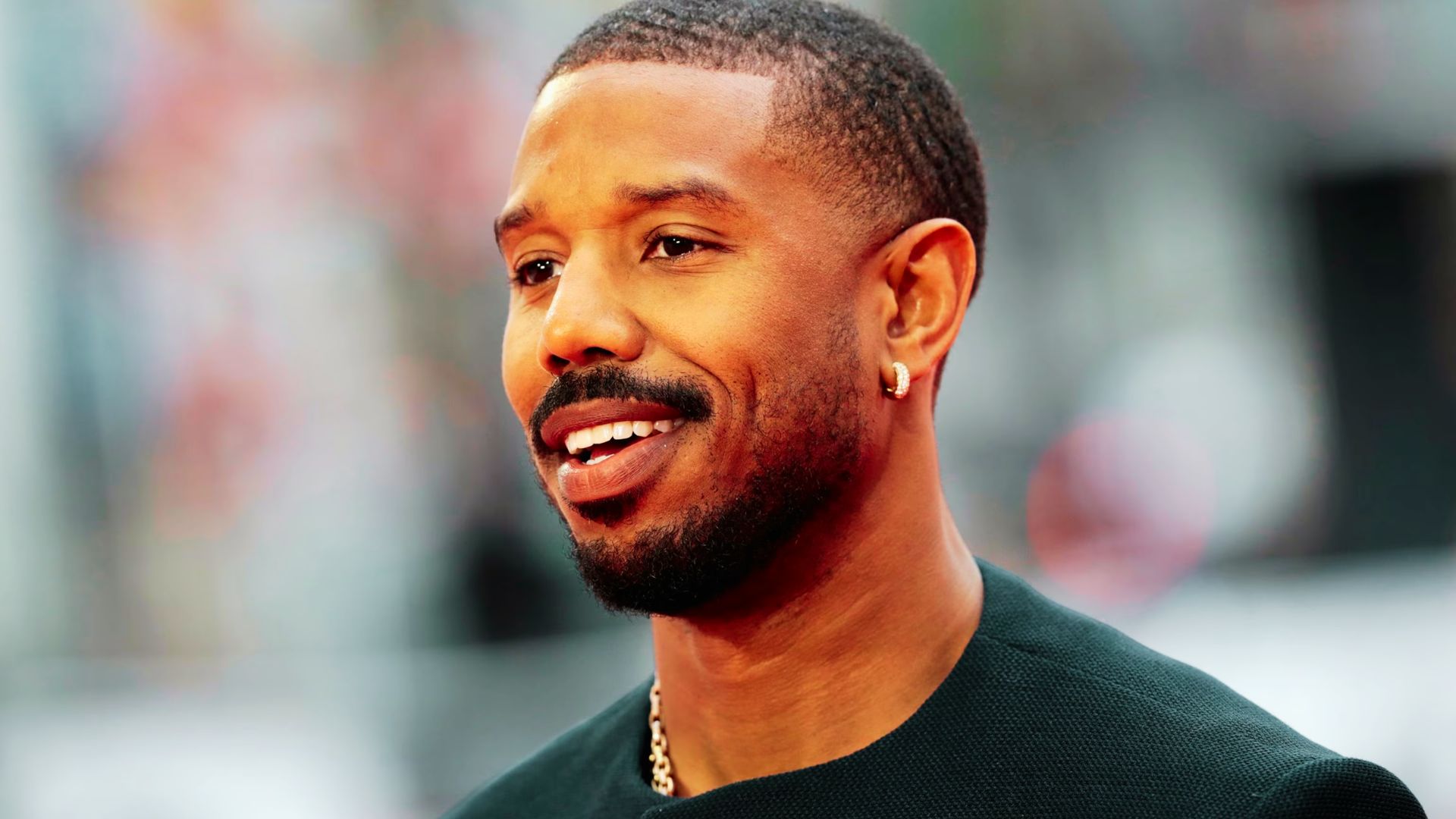 Michael B. Jordan on a red carpet with a 360 waves haircut and sharp line-up.