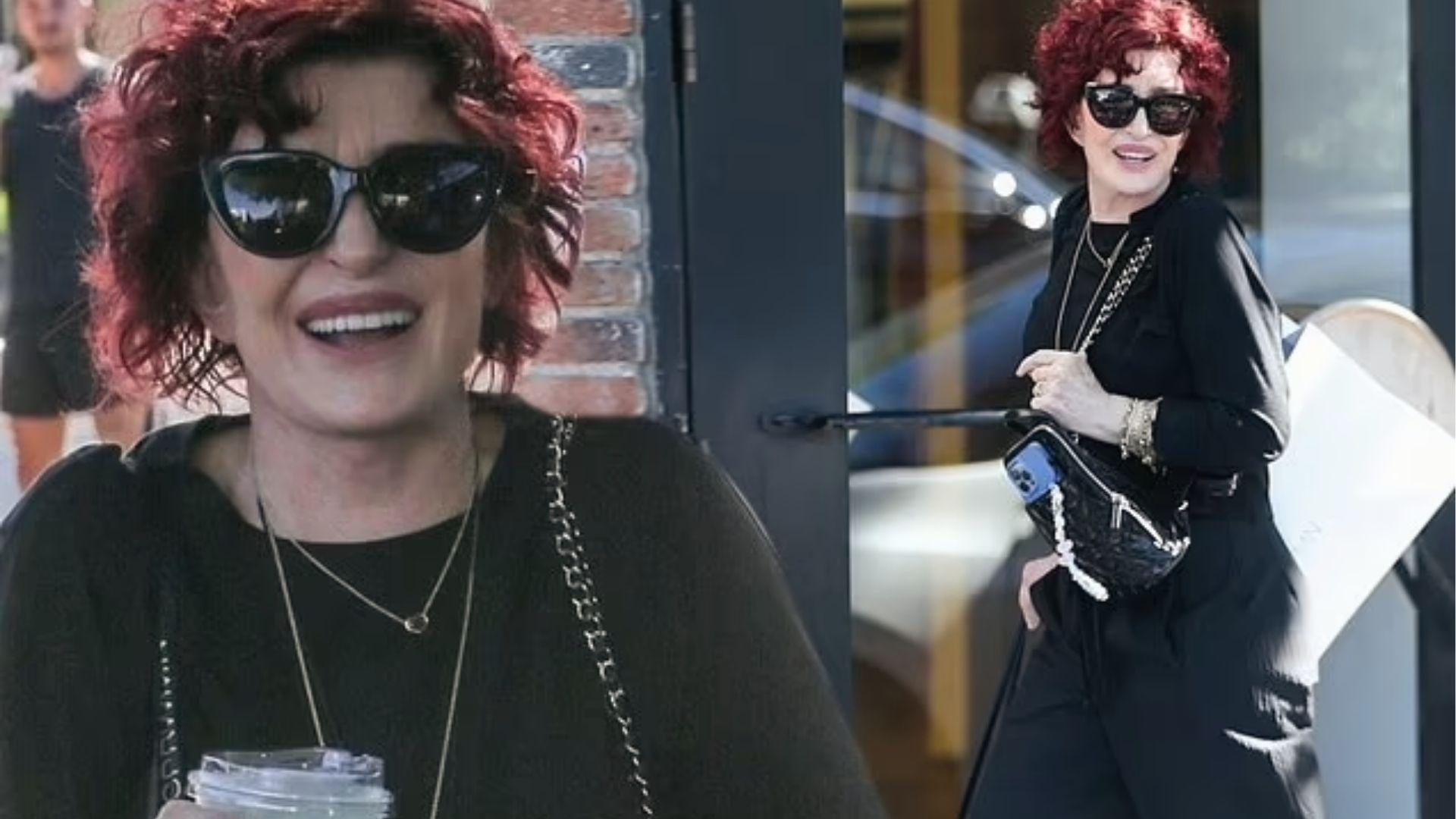 Sharon Osbourne laughs in all-black outfit with chain bag and cat-eye sunglasses